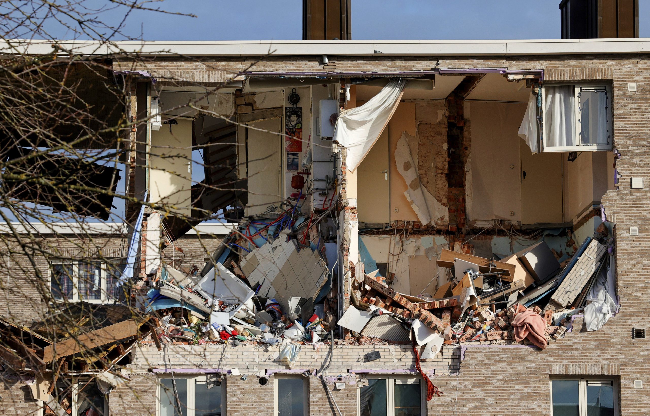 Rubble is scattered in apartments of a building after a blast occurred in Turnhout, Belgium, Friday, Dec. 31, 2021. Rescue services said it was still unclear what caused the blast or if there are casualties. (AP Photo/Olivier Matthys)
