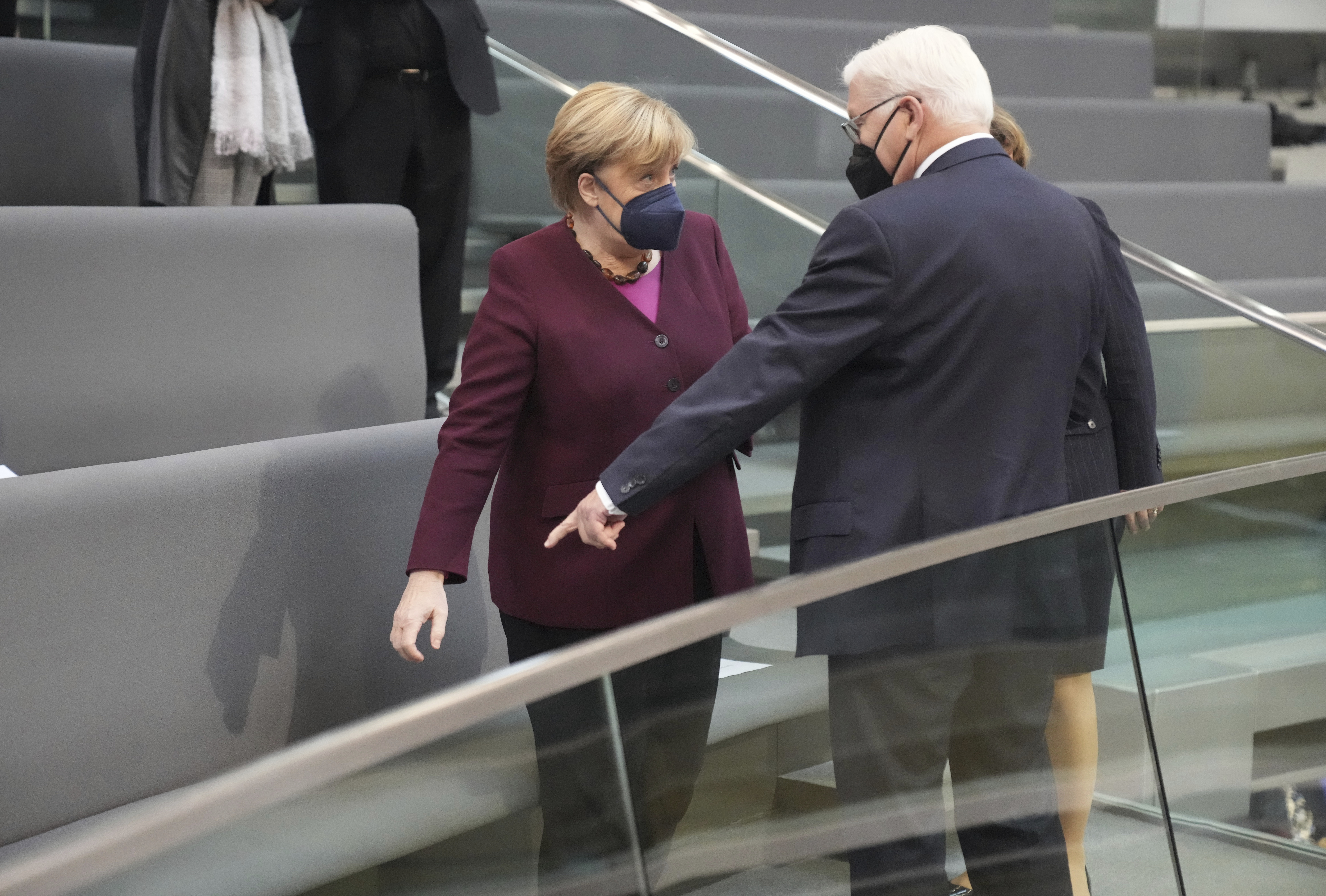 German chancellor Angela Merkel arrives besides German president Frank-Walter Steinmeier for the first plenary session of the German Bundestag after the elections in Berlin, Tuesday, Oct. 26, 2021. (Michael Kappeler/dpa via AP)