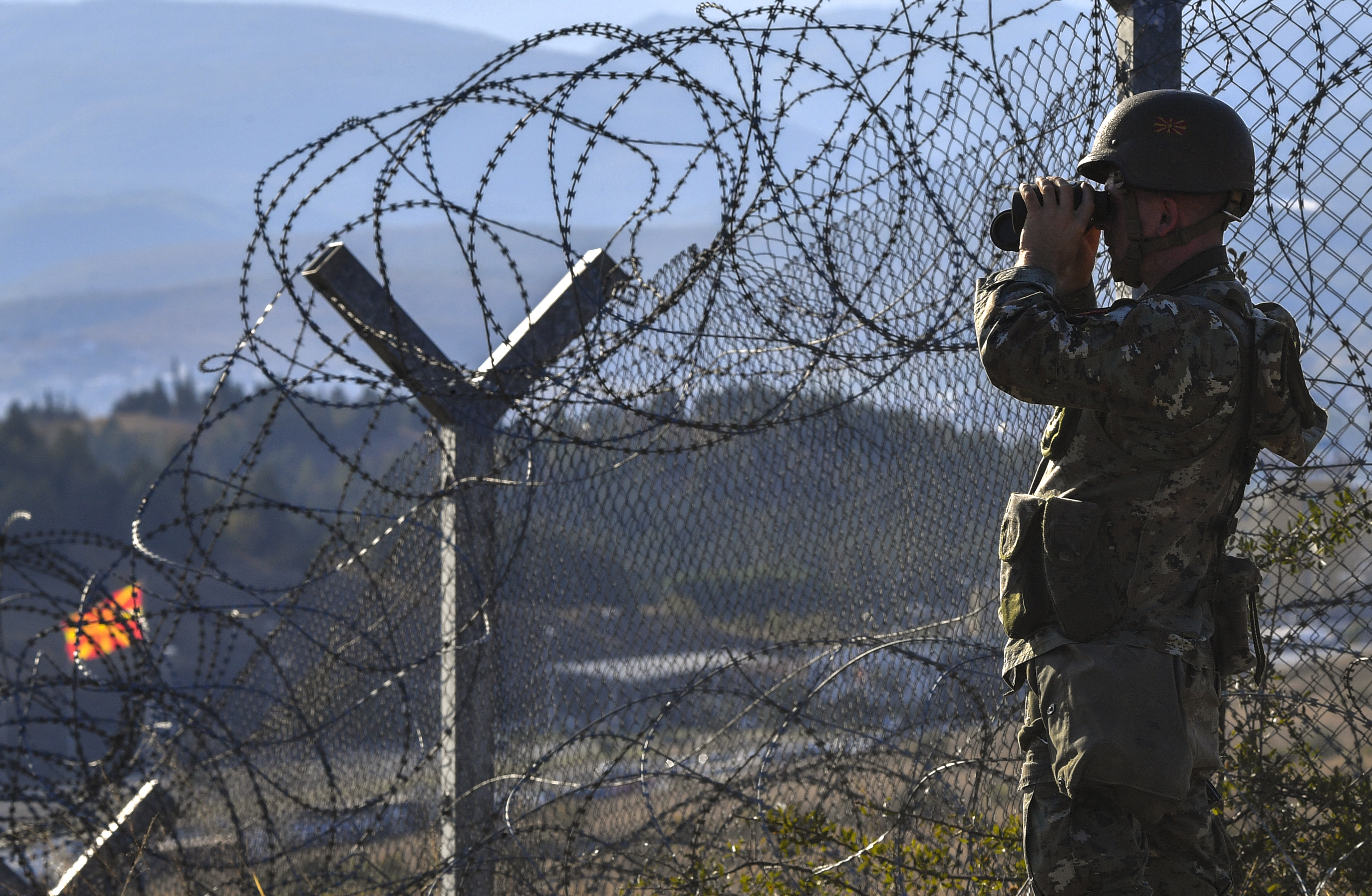 Macedonian soldier patrols the Macedonian border with Greece