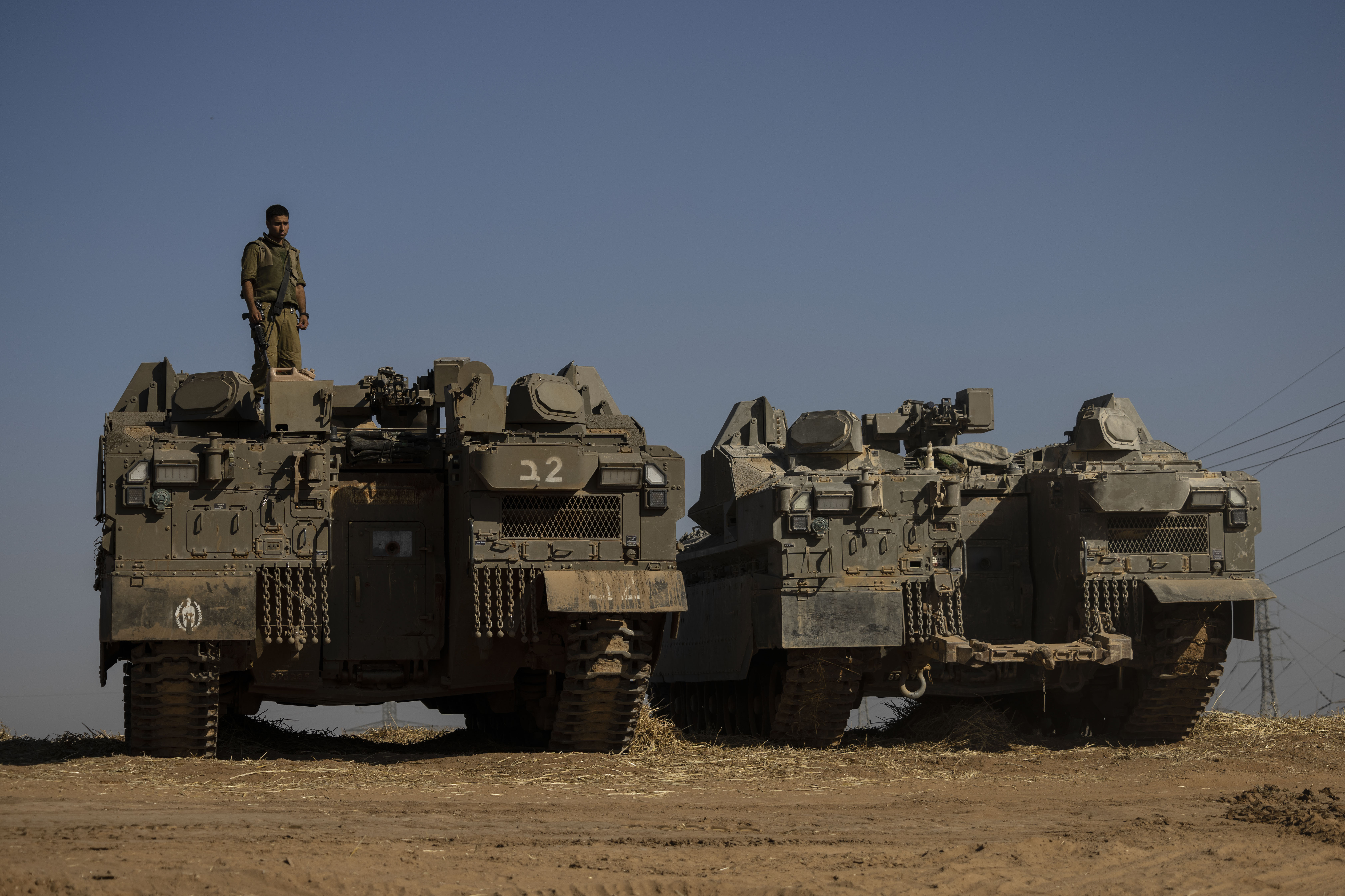 Israeli soldiers with armored vehicles gather in a staging ground near the border with Gaza Strip, southern Israel, Friday, May 14, 2021. (AP Photo/Tsafrir Abayov)