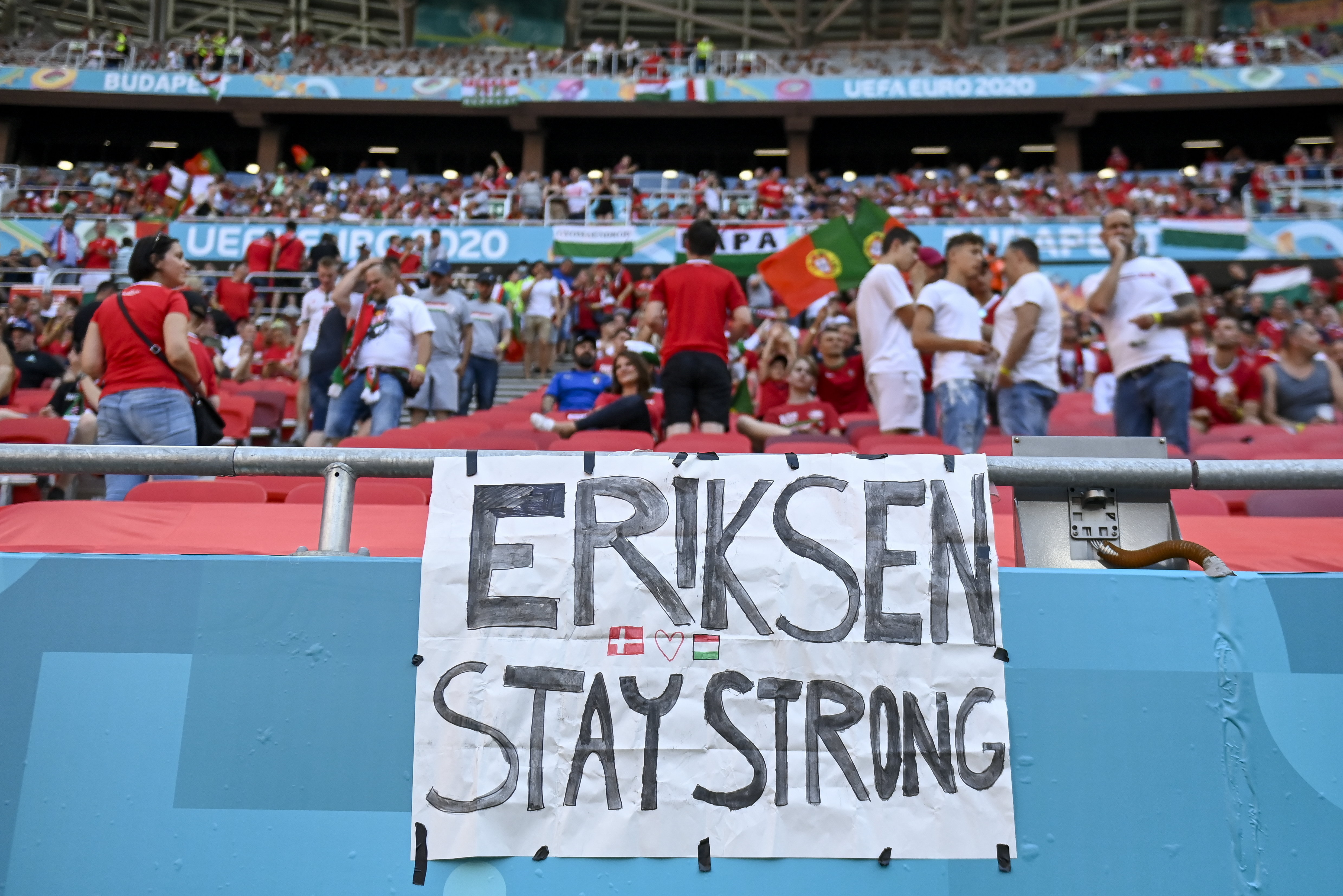 epa09273655 A message is written on a banner to Danish football player Christian Eriksen prior to the UEFA EURO 2020 group F preliminary round soccer match between Hungary and Portugal in Budapest, Hungary, 15 June 2021.  EPA-EFE/Tamas Kovacs Pool fotó