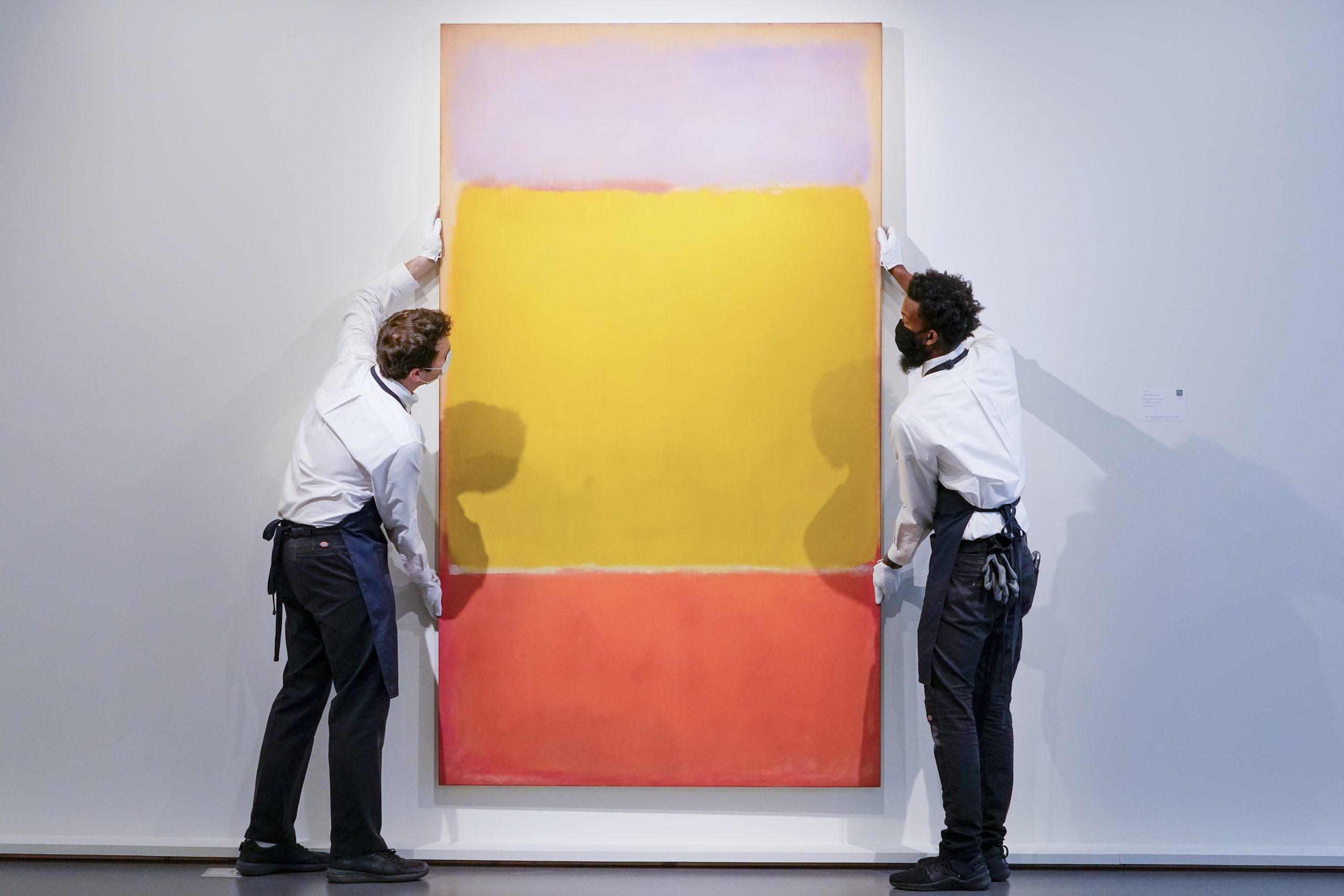 Art handlers adjust Mark Rothko's "No. 7" on display at Sotheby's auction house during a press preview for the upcoming The Macklowe Collection auction, Friday, Nov. 5, 2021, in New York. (AP Photo/Mary Altaffer)