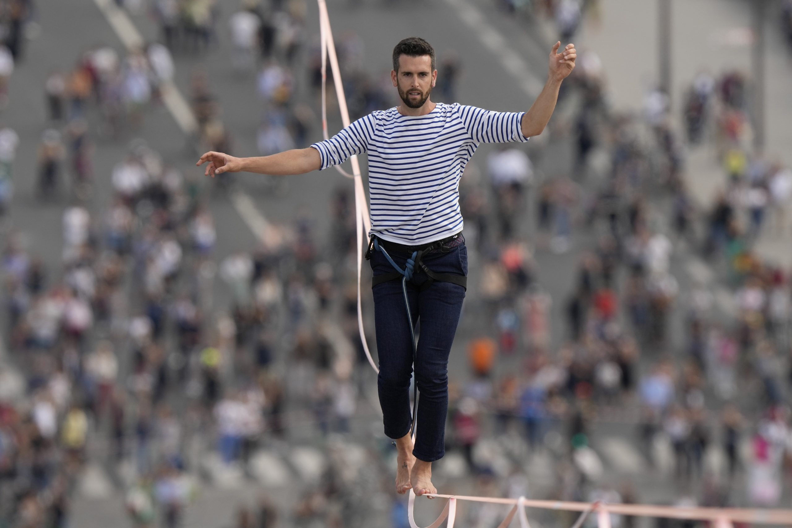 French slackliner Nathan Paulin performs on the second time on a 70-meter-high slackline between the Eiffel Tower and the Chaillot Theater across the Seine River, in Paris Sunday, Sept. 19, 2021. (AP Photo/Francois Mori)