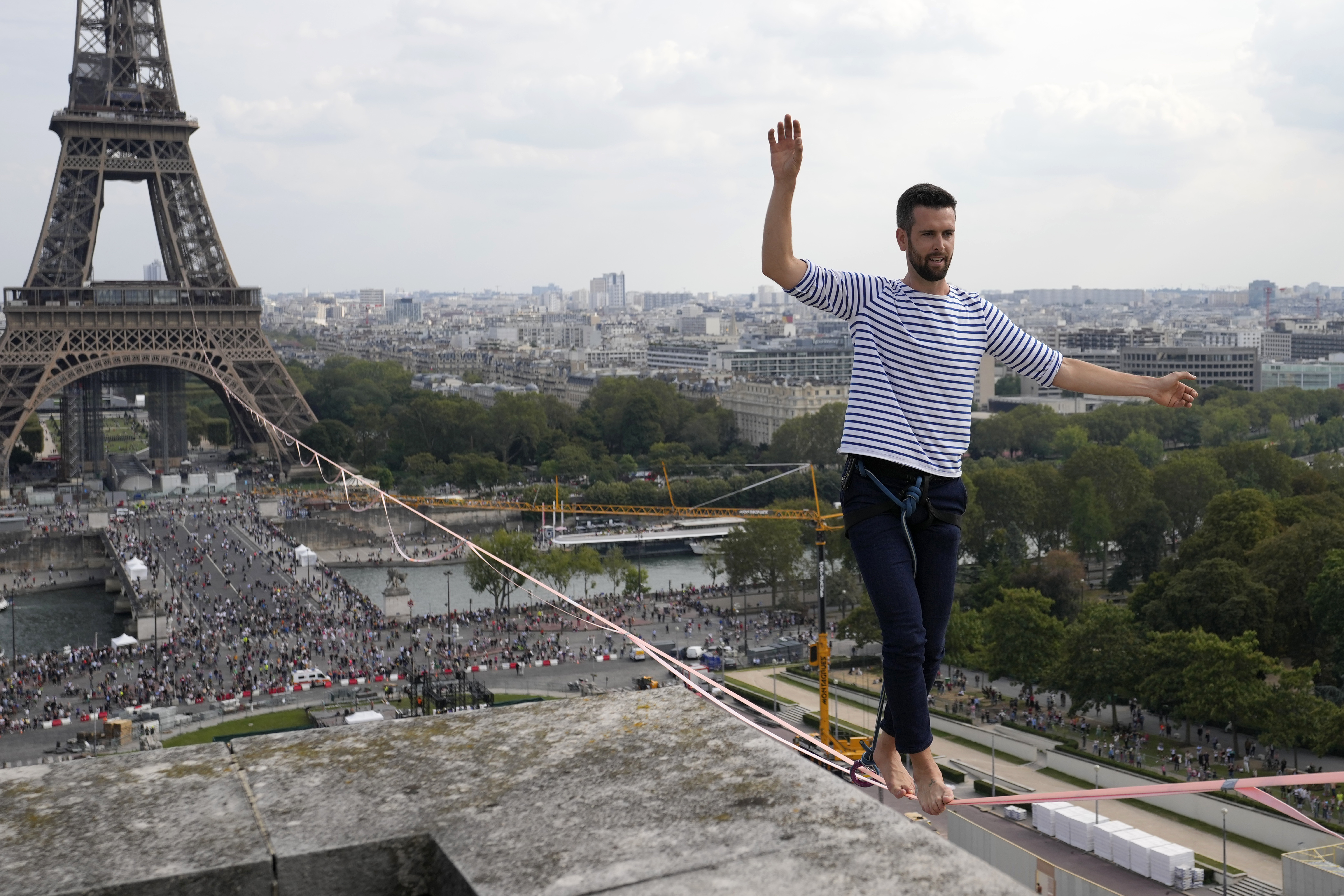 French slackliner Nathan Paulin performs on the second time on a 70-meter-high slackline between the Eiffel Tower and the Chaillot Theater across the Seine River, in Paris Sunday, Sept. 19, 2021. (AP Photo/Francois Mori)