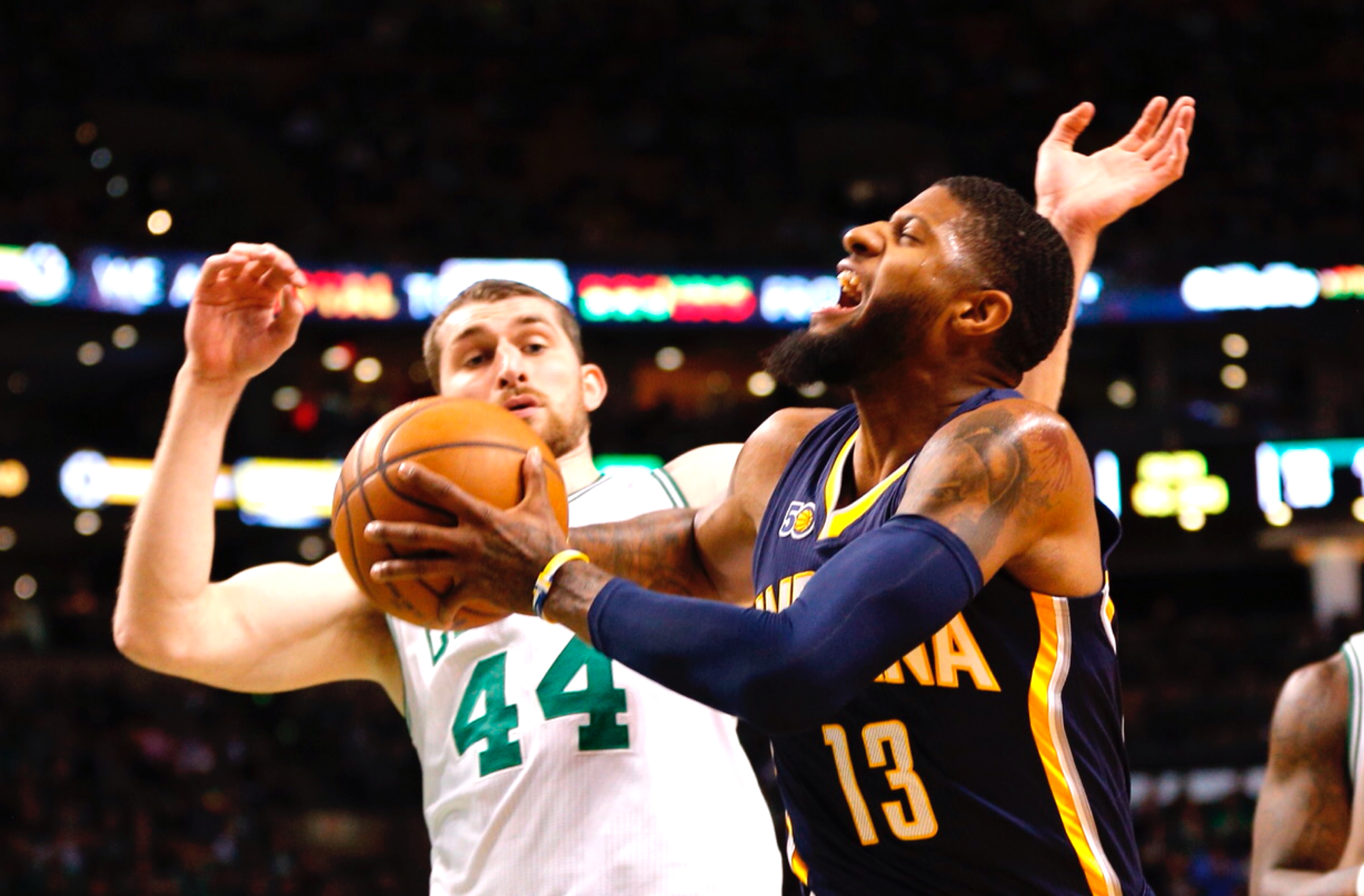 Indiana Pacers forward Paul George (R) and Boston Celtics center Tyler Zeller (L) collide under the net during the first half at TD Garden in Boston, Massachusetts, USA 22 March 2017.
