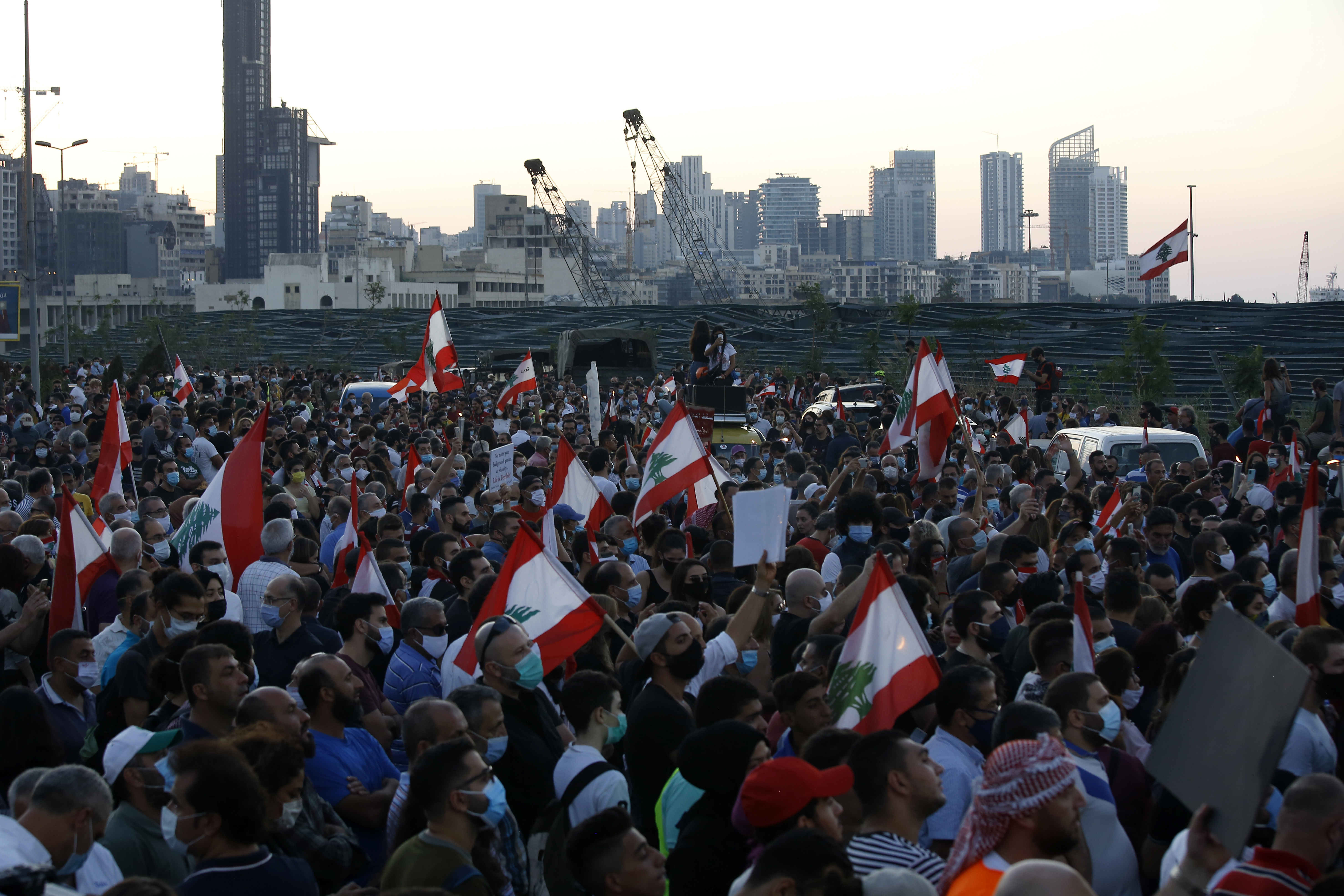 Anti-government protesters march in Beirut to mark the first anniversary of protest movement