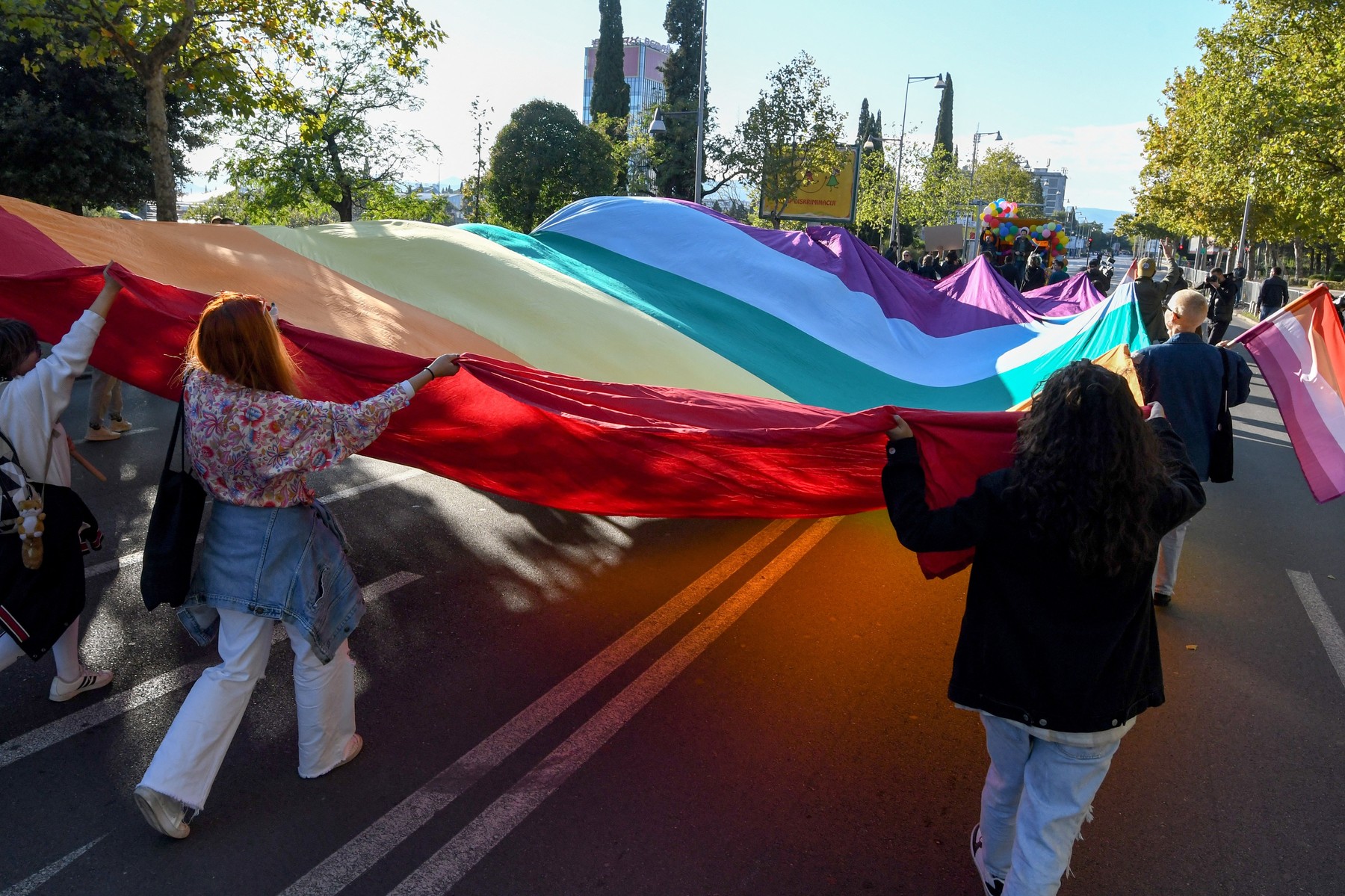 People hold a huge rainbow flag during the Pride march in Podgorica, Montenegro, on October 16, 2021.,Image: 638242054, License: Rights-managed, Restrictions: , Model Release: no, Credit line: SAVO PRELEVIC / AFP / Profimedia
