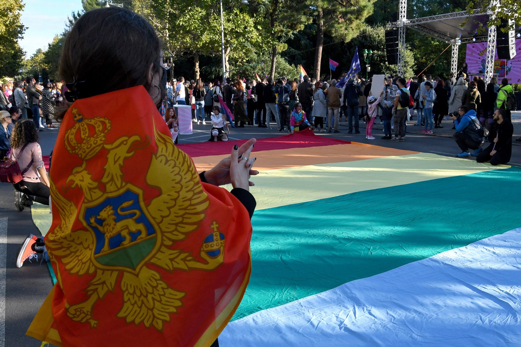 People gather around a huge rainbow flag during the Pride march in Podgorica, Montenegro, on October 16, 2021.,Image: 638242068, License: Rights-managed, Restrictions: , Model Release: no, Credit line: SAVO PRELEVIC / AFP / Profimedia