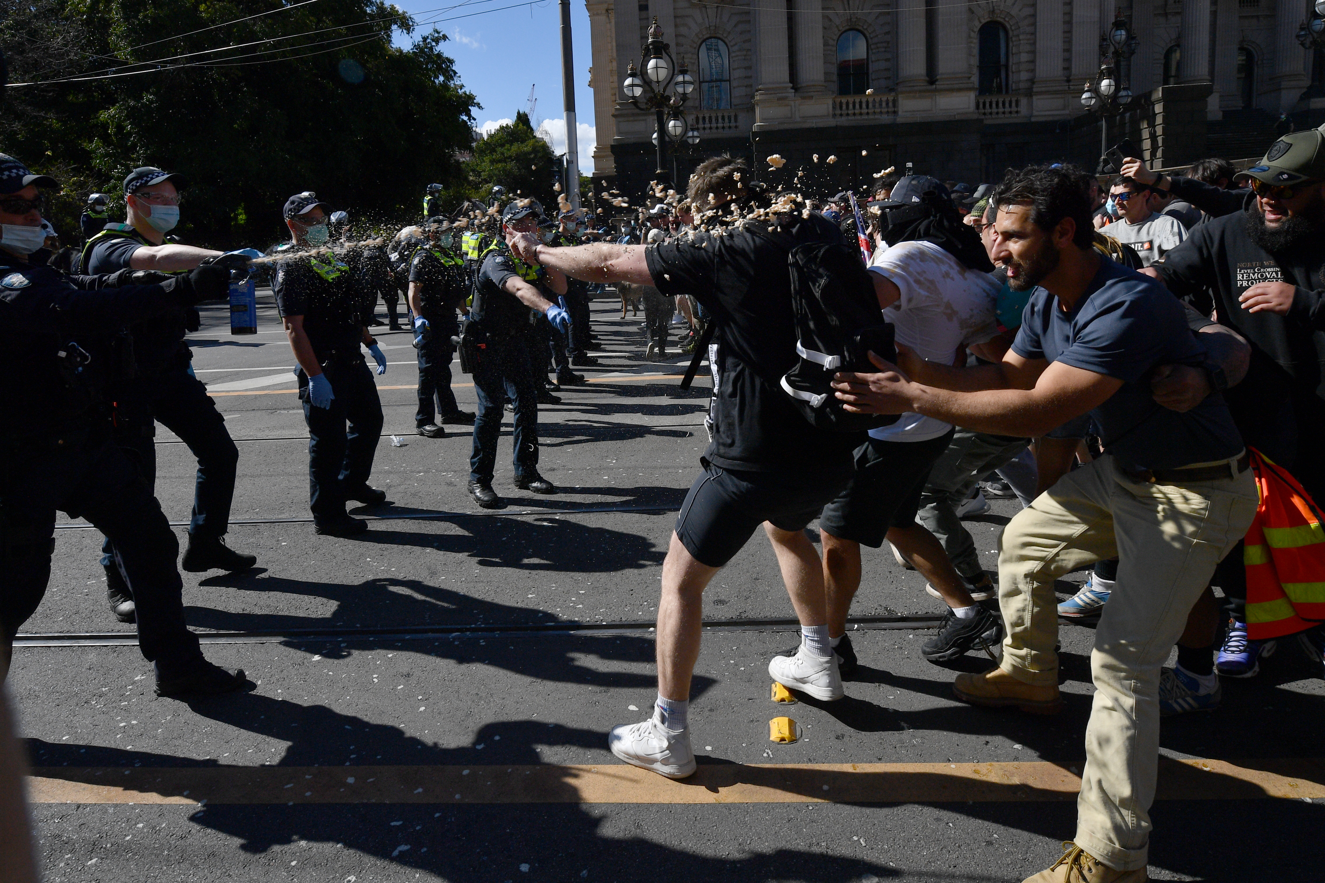 epa09422744 Protesters are pepper sprayed by police during an anti-lockdown protest in the central business district of Melbourne, Australia, 21 August 2021.  EPA-EFE/JAMES ROSS AUSTRALIA AND NEW ZEALAND OUT
