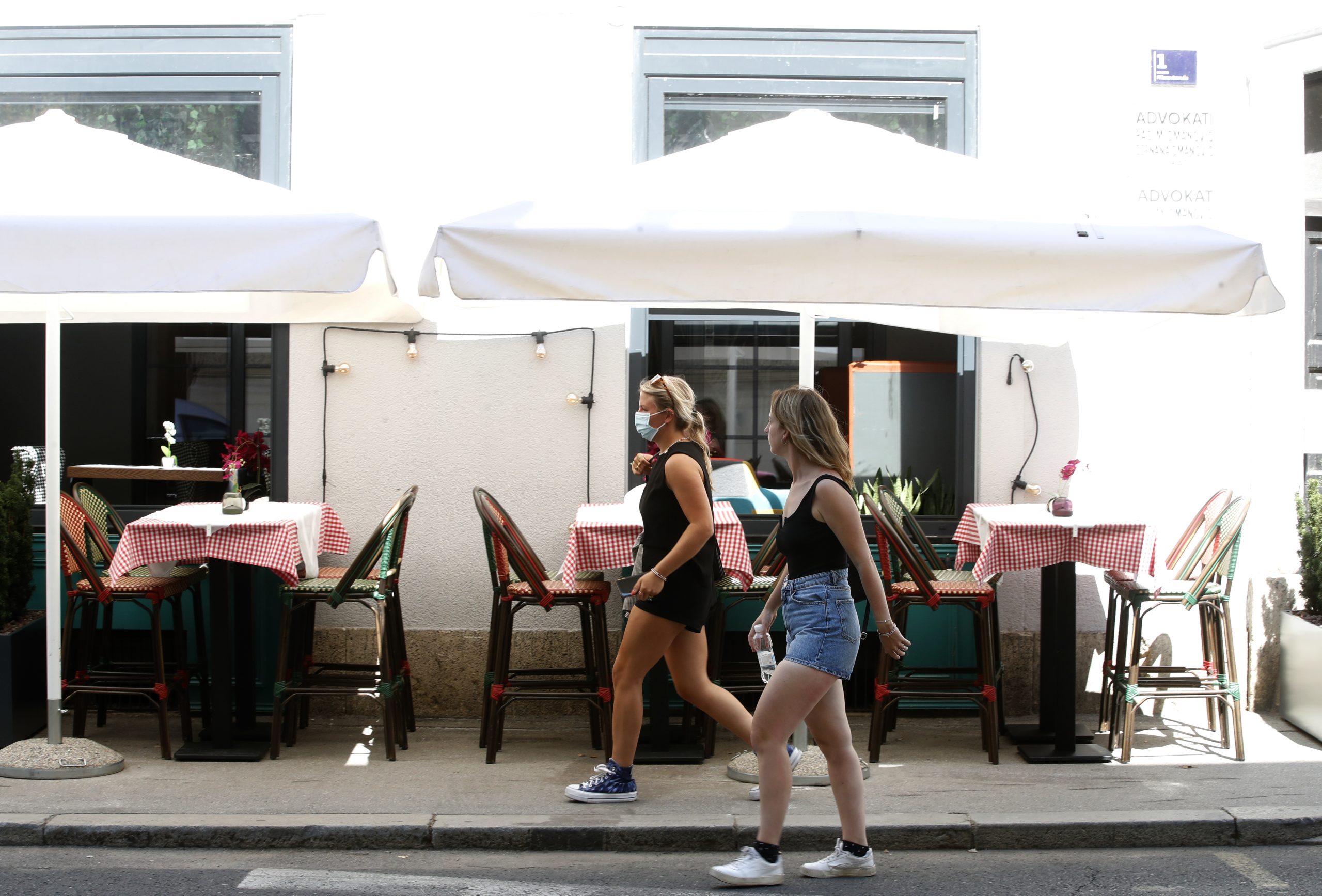 epa09420187 Two women pass by an empty restaurant in the downtown of Zagreb, Croatia, 19 August 2021. New cases of infected people by COVID-19 coronavirus rose up in Croatia. Zagreb is expected to be in the red zone soon.  EPA-EFE/ANTONIO BAT