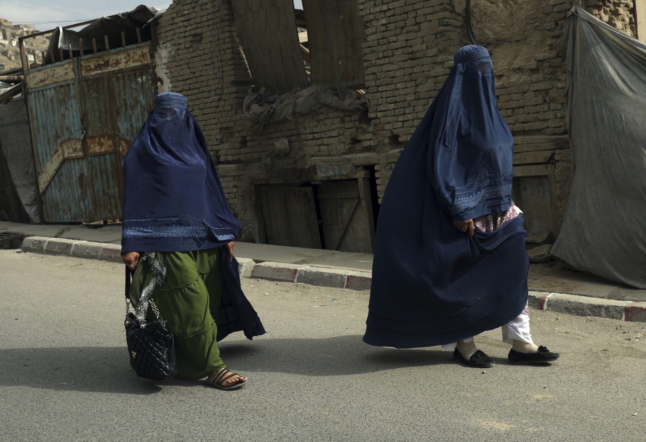 Afghan women in burqas walk on a street in Kabul, Afghanistan, Sunday, Aug. 22, 2021. (AP Photo/Rahmat Gul)