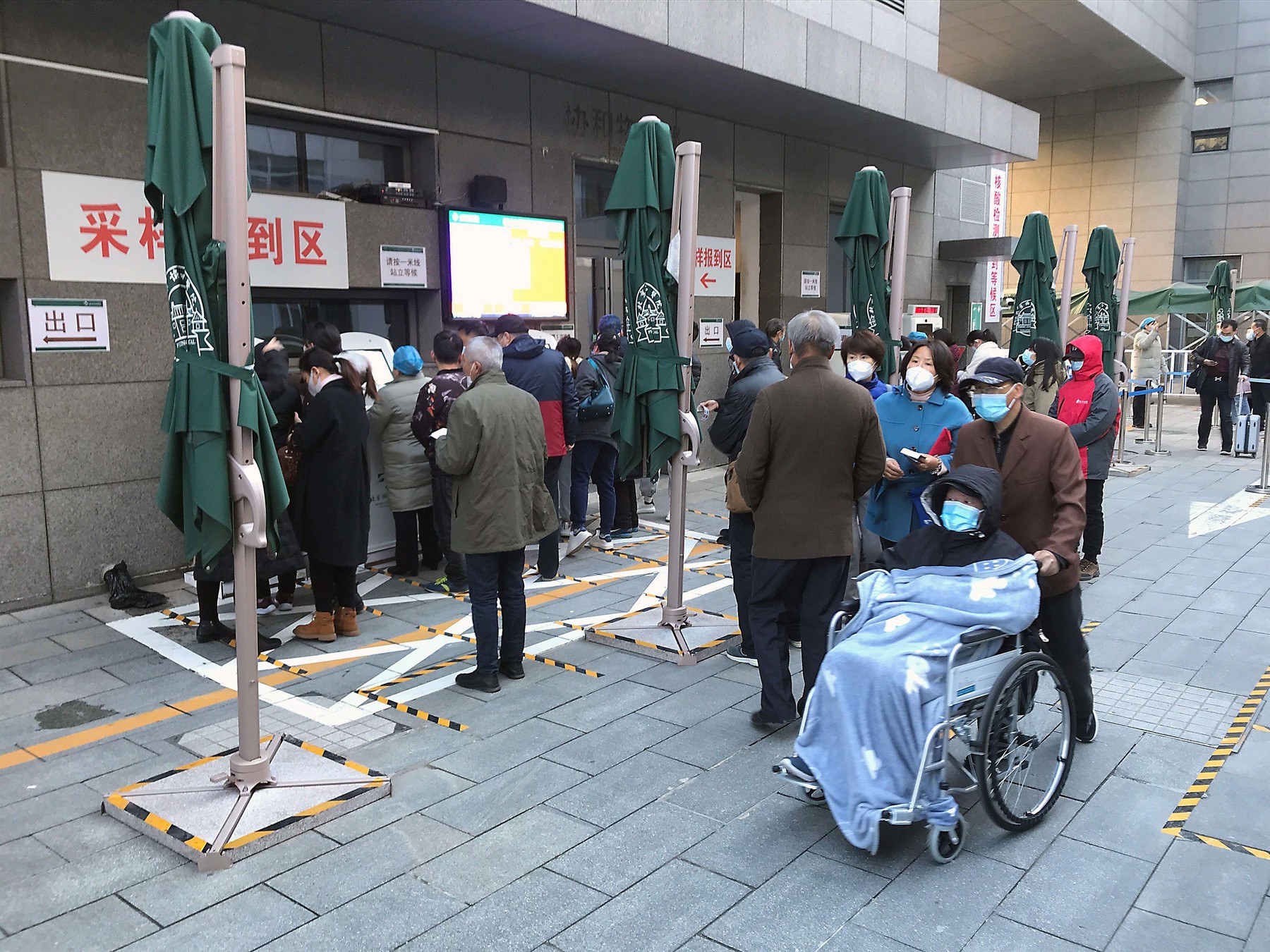 Beijing, China. 23rd Nov, 2020. Chinese wait in line to register for a Coved-19 infection test at a state hospital in Beijing on Monday, November 23, 2020. Chinese health authorities are testing millions of people in several cities, imposing lockdowns and