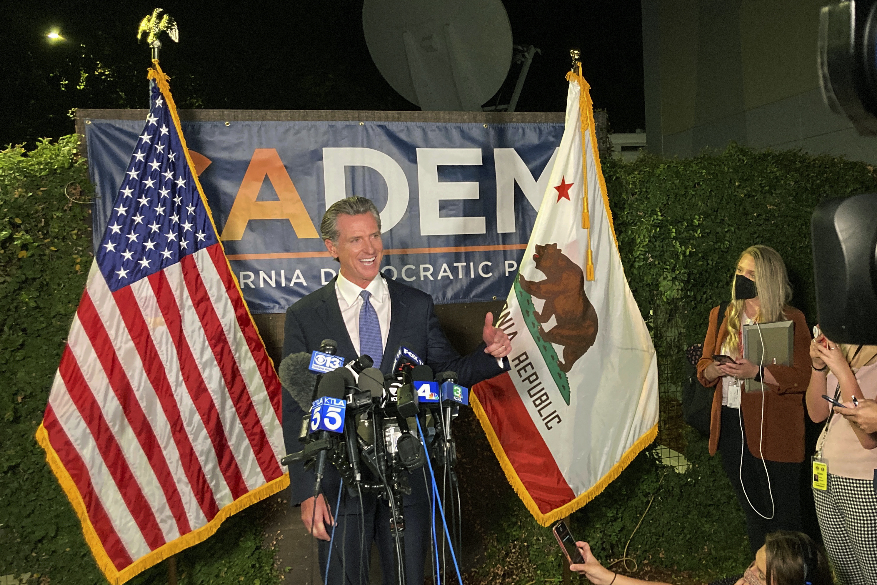 Gov. Gavin Newsom addresses a crowd in Sacramento, Calif., on Tuesday night, Sept.14, 2021. Newsom defeated an attempt to oust him from office, overcoming Republican criticism of COVID-19 restrictions that shuttered schools and businesses. (8