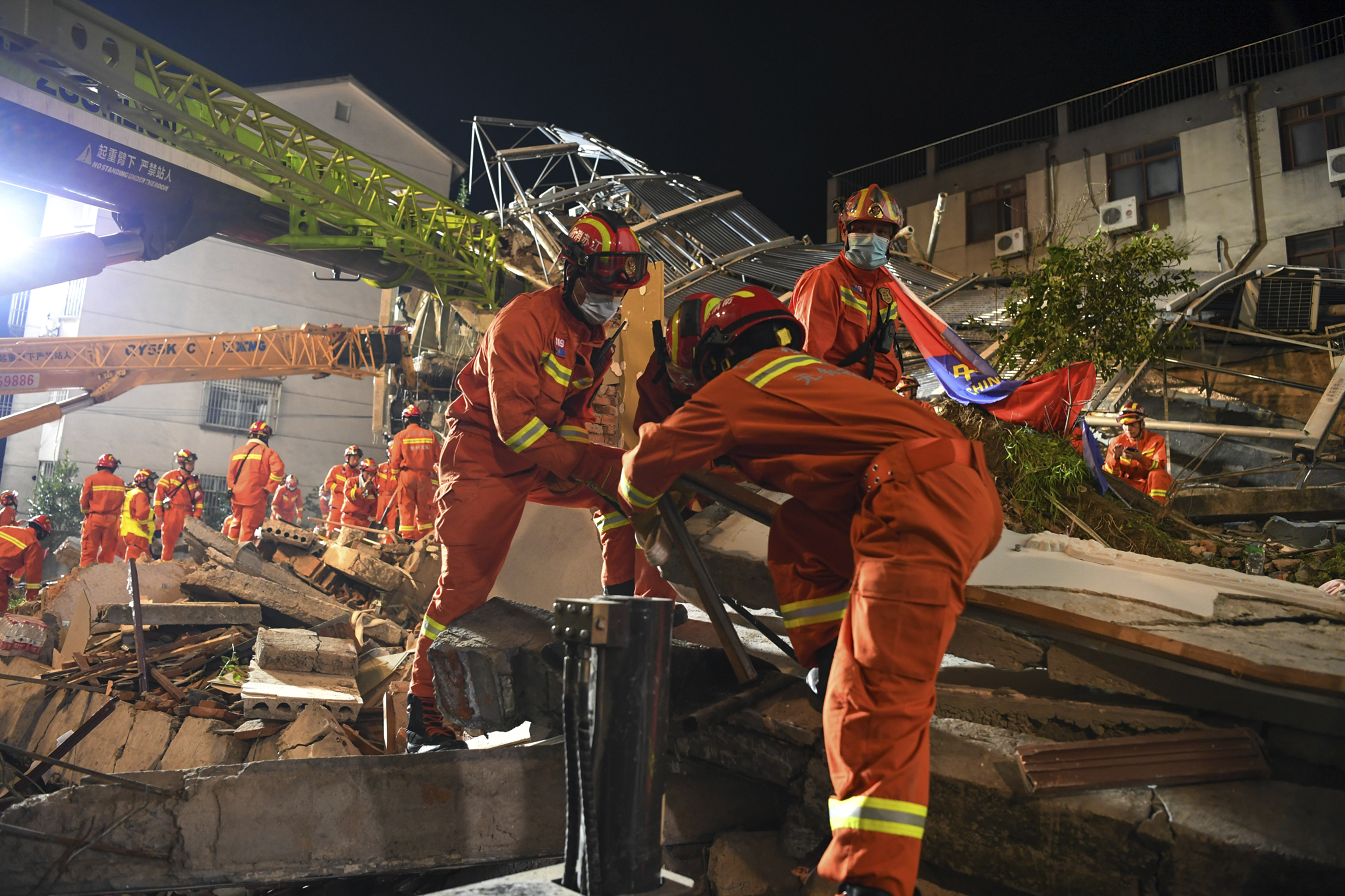 In this photo released by Xinhua News Agency, rescuers prepare equipment as they search for survivors at a collapsed hotel in Suzhou in eastern China's Jiangsu Province on Monday, July 12, 2021. The hotel building collapsed Monday afternoon.