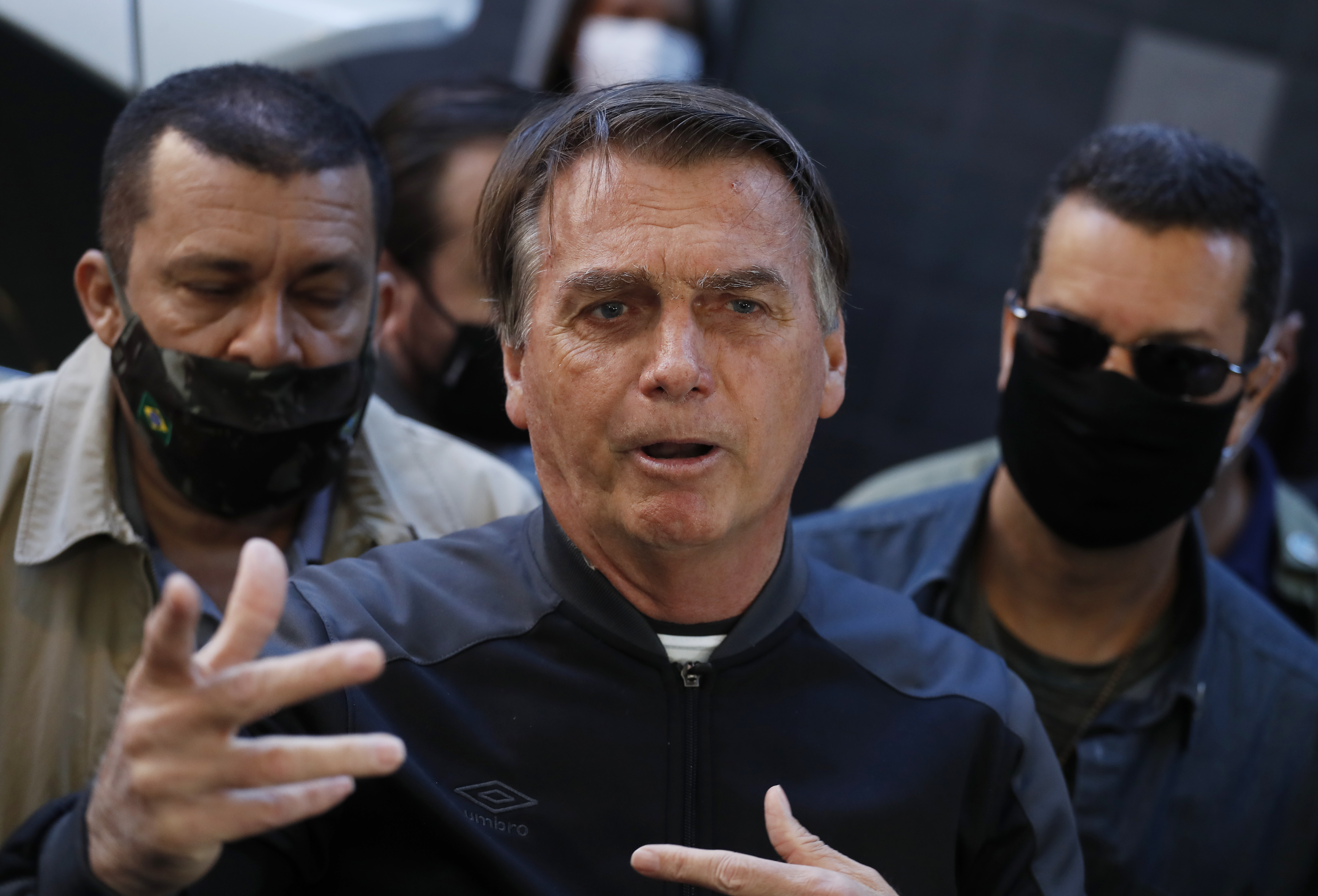 Brazil's President Jair Bolsonaro speaks to reporters as he leaves the hospital after recovering from an intestinal obstruction in Sao Paulo, Brazil, Sunday, July 18, 2021. (AP Photo/Nelson Antoine)