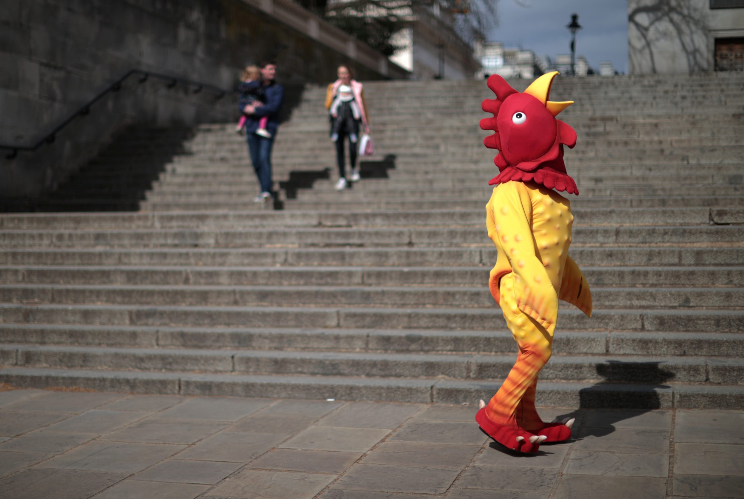 02042021 A person dressed in a chicken costume walks through Westminster on Good Friday in London, Britain, April 2, 2021. REUTERS/Hannah McKay