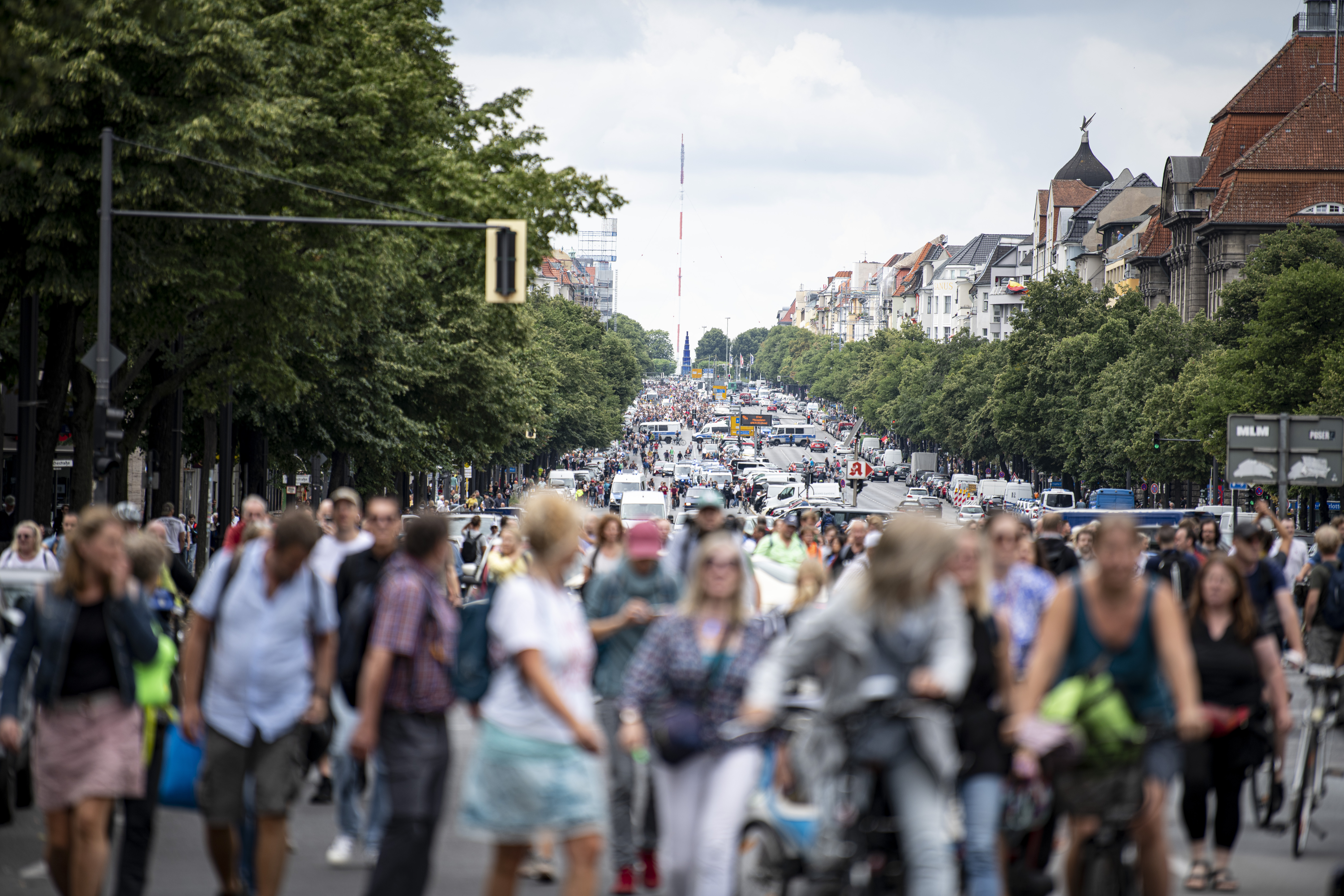 Demonstrators walk along Bismarckstrasse in Berlin, Sunday Aug. 1, 2021, during a protest against coronavirus restrictions. (Fabian Sommer/dpa via AP)