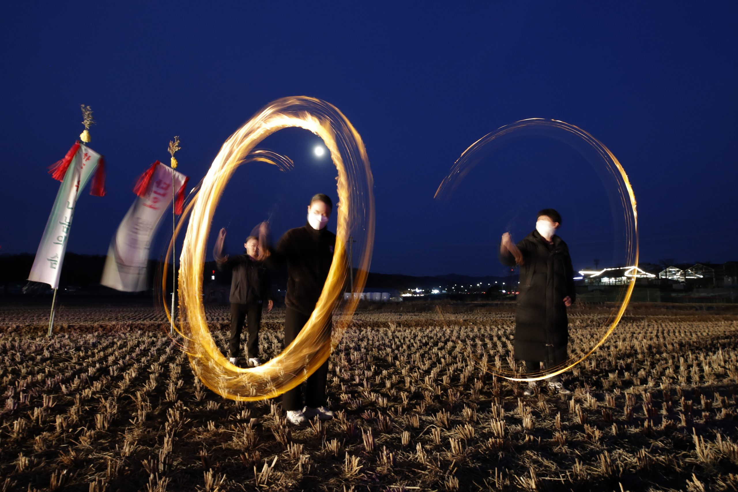 26022021 People twirl cans with holes filled with burning wood chips and straw to celebrate the first full moon of the Lunar New Year, in Siheung, South Korea, Friday, Feb. 26, 2021. (AP Photo/Lee Jin-man)