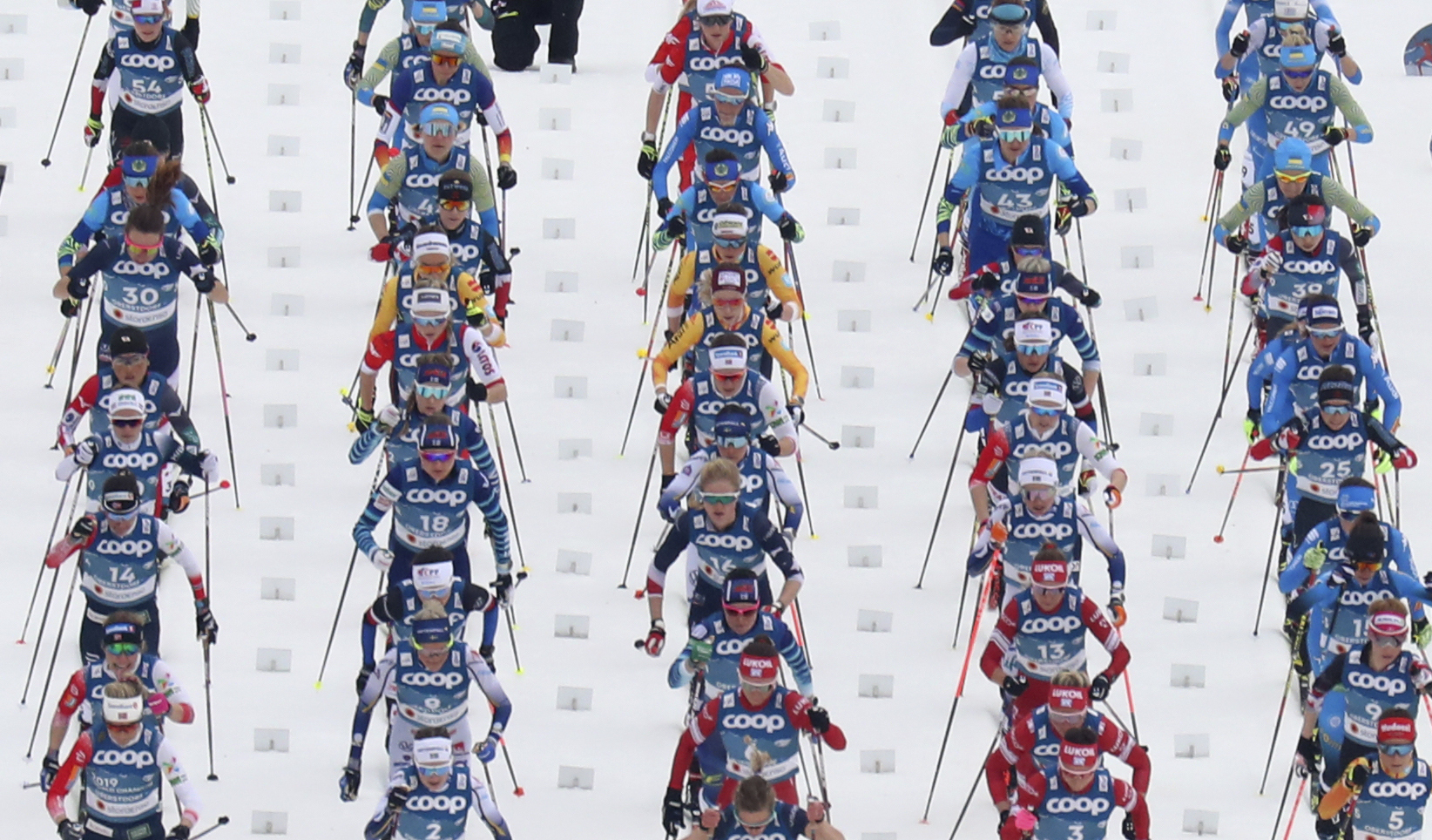 Competitors during the mass start of the WSC Women's Skiathlon 15km cross country event at the FIS Nordic World Ski Championships in Oberstdorf, Germany, Saturday, Feb. 27, 2021. (AP Photo/Matthias Schrader)