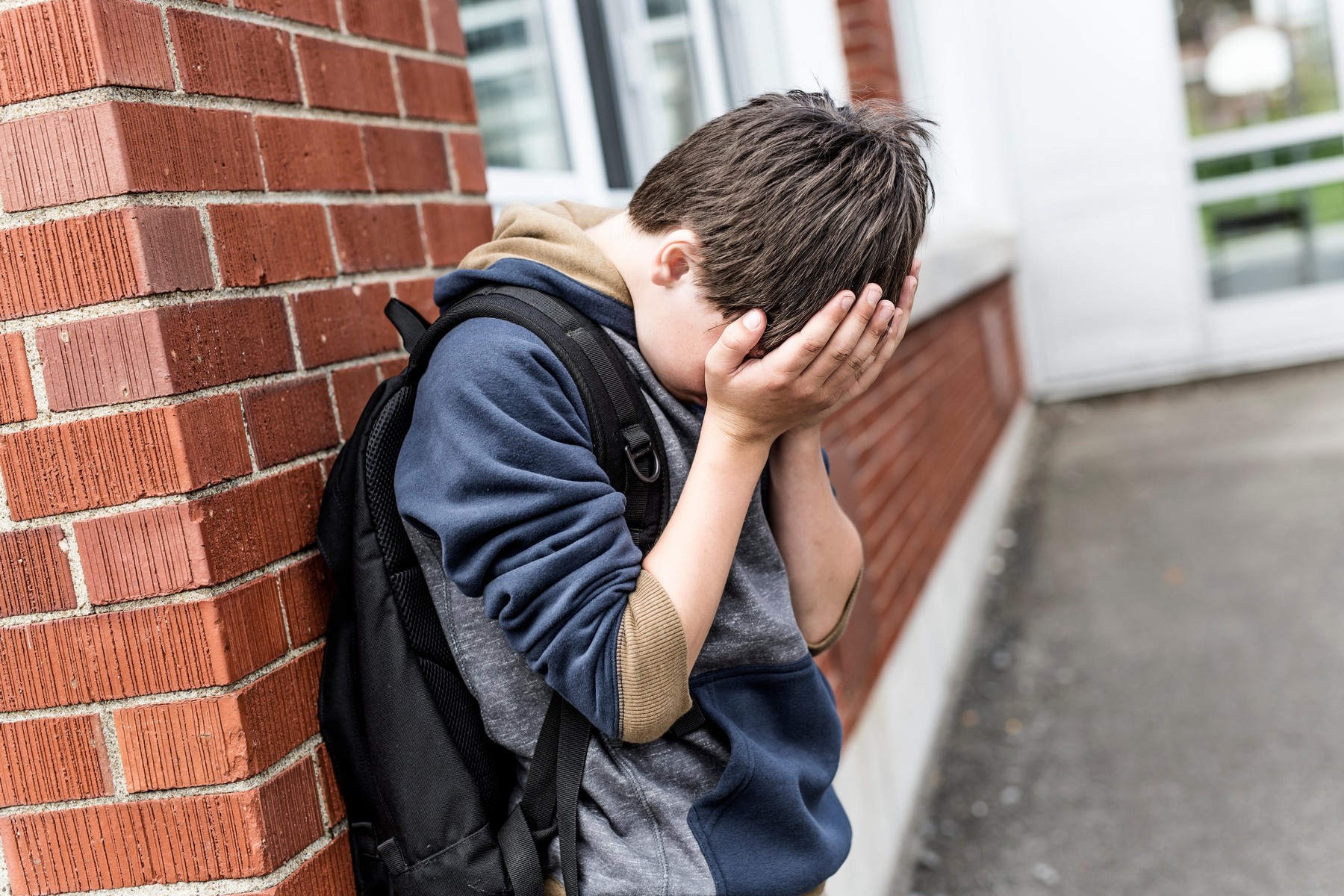 A Unhappy depress Pre teen boy at school