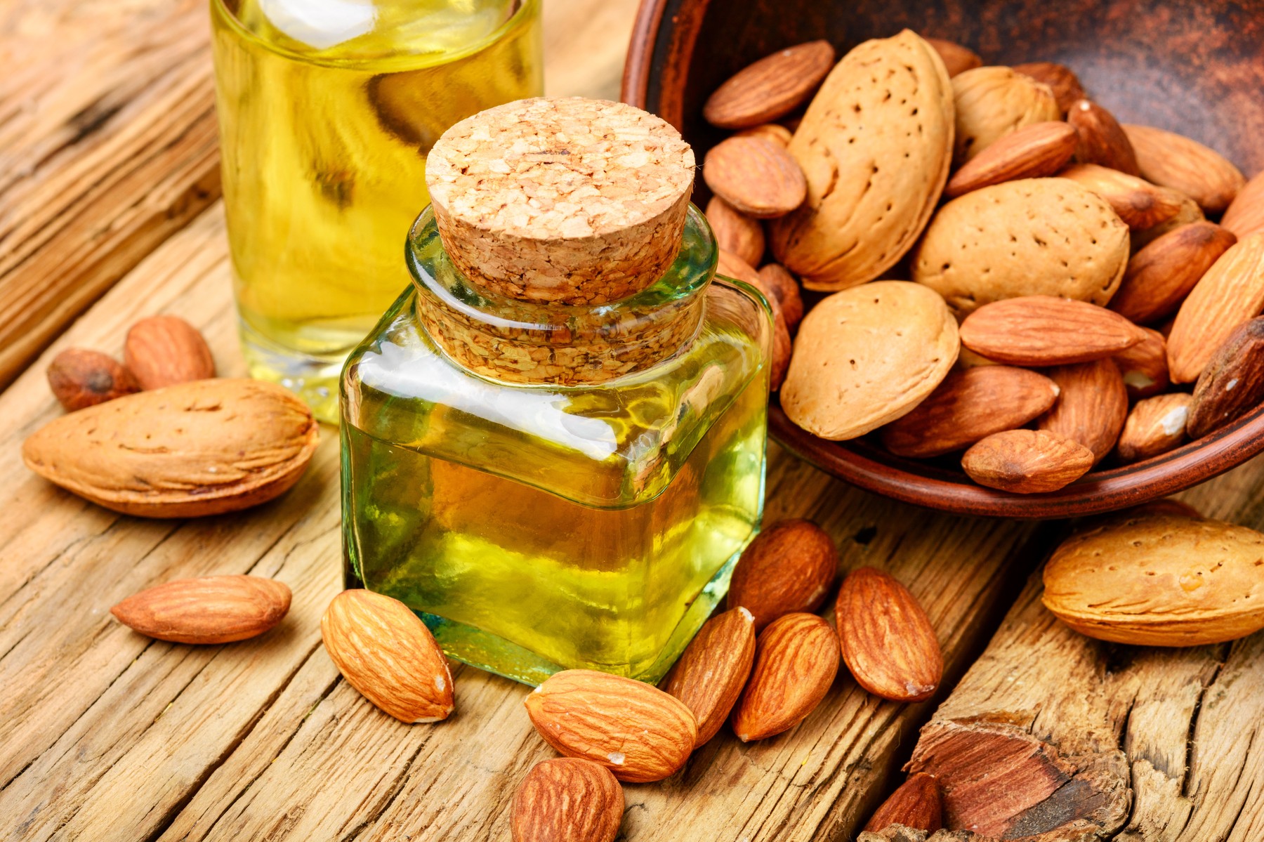 Almond oil in bottle and nuts