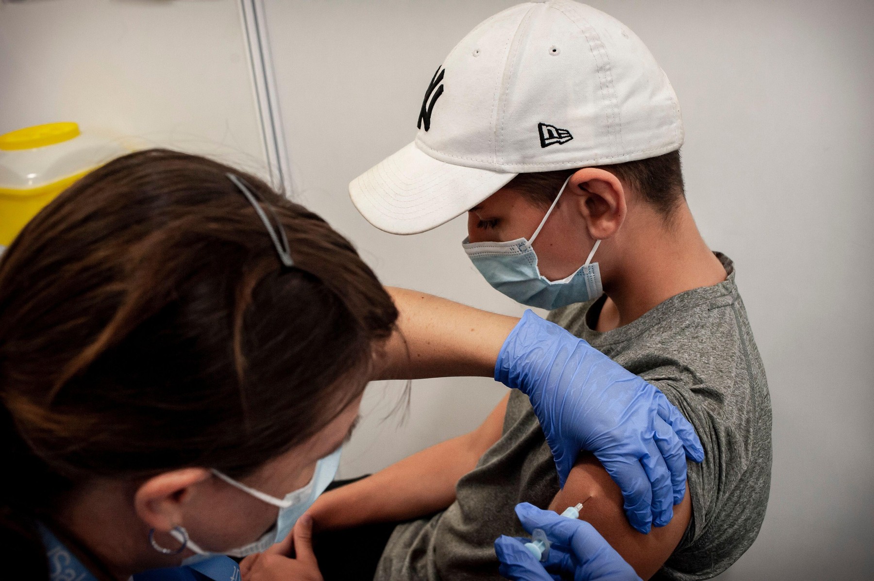 Pol (13 years old) receives his second shot of Moderna vaccine in Barcelona.