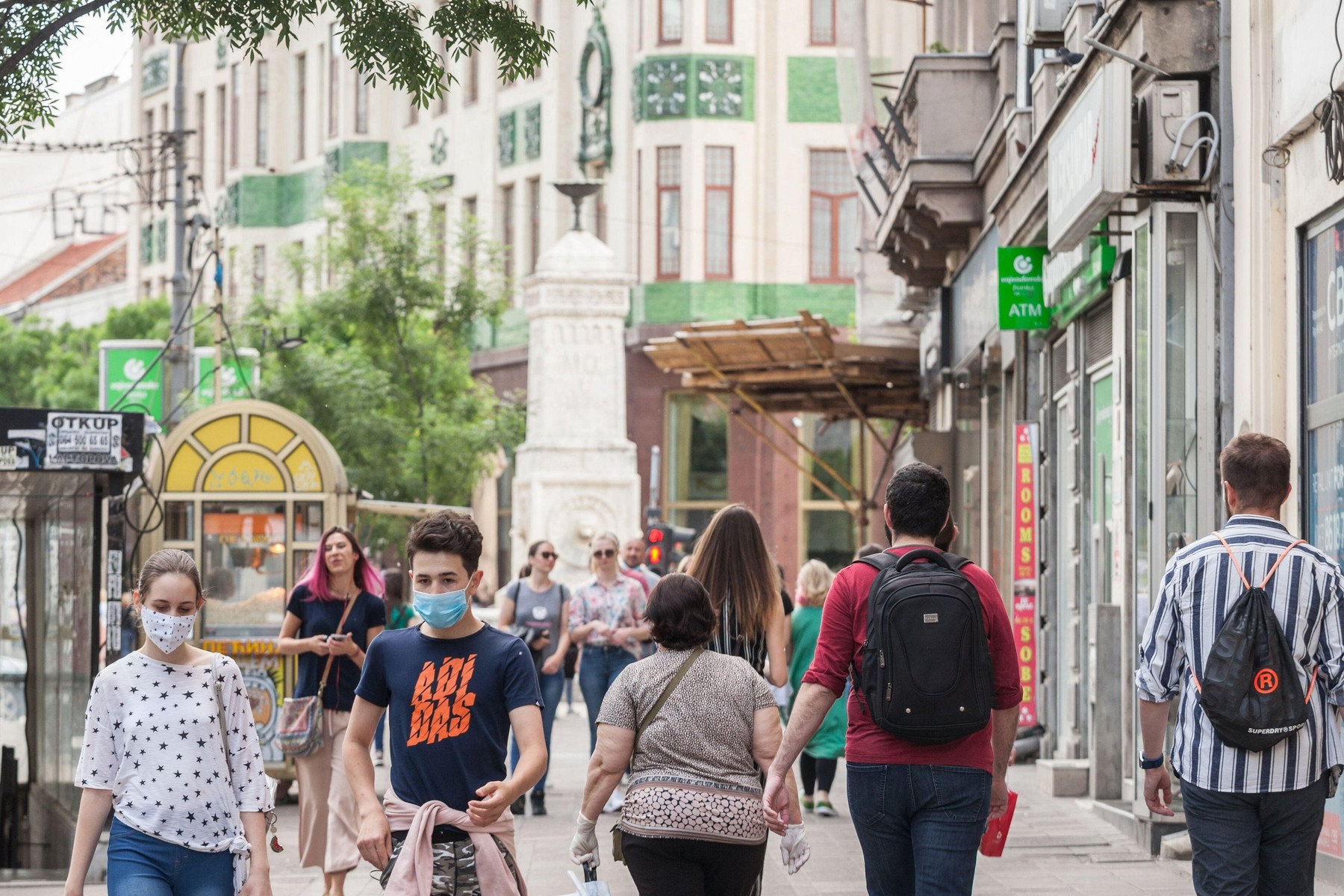 BELGRADE, SERBIA - MAY 9, 2020: Young people, a young man and a young girl, friends, walking wearing face mask protective equipement on Coronavirus Co