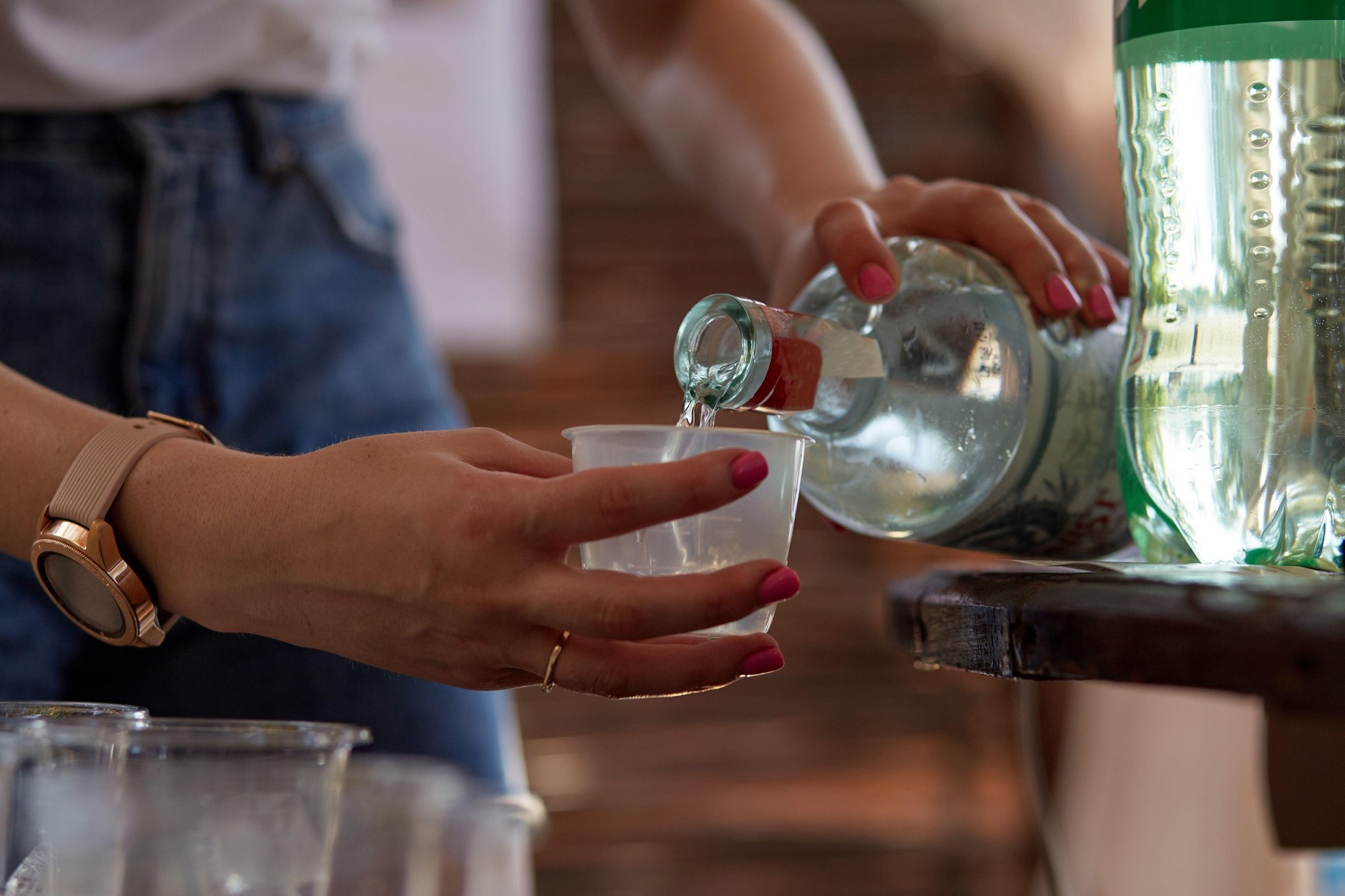 Kyiv, Ukraine - July 10, 2021: Young woman at a bachelorette party makes a mojito cocktail for the company with rum and Sprite. Preparation instructio
