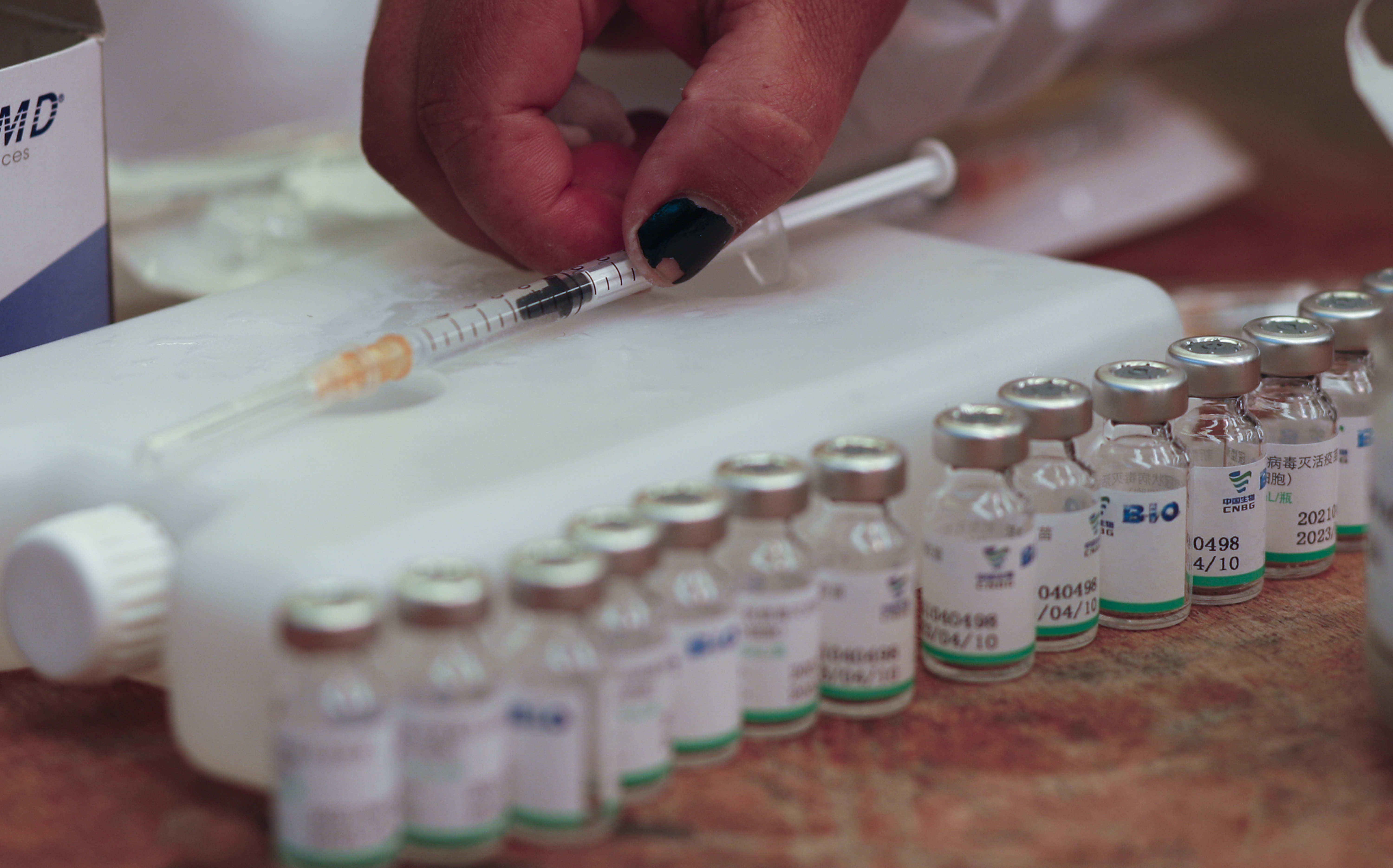A nurse prepares a shot of the Sputnik V vaccine for COVID-19 as people over age 40 get vaccinated at the American Institute school in La Paz, Bolivia, Friday, June 4, 2021. (AP Photo/Juan Karita)