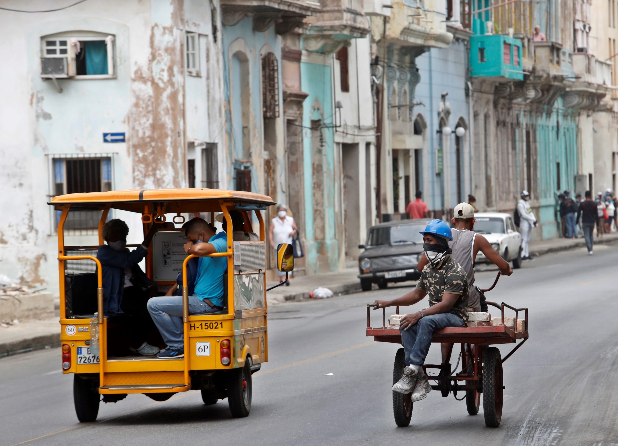 epa08935785 People ride tricycles in a street, in Havana, Cuba, 13 January 2021.  EPA-EFE/Yander Zamora