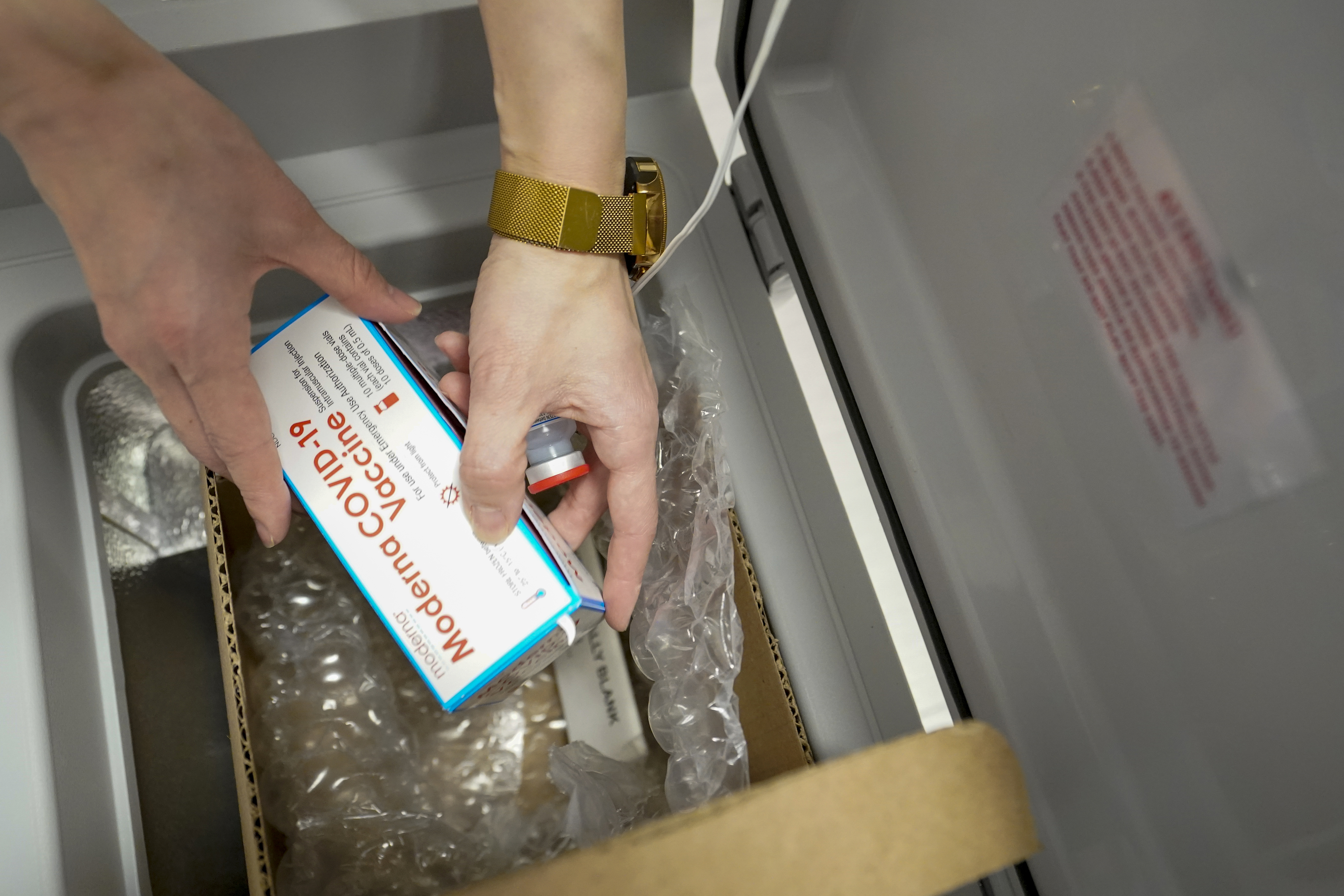 Pharmacist Mia Yu removes a vial of the Moderna COVID-19 vaccine from the refrigerator at a pop up site at Commonpoint Queens The Hub in partnership with the UJA- Federation of New York, Thursday, March 18, 2021, in New York. (AP Photo/Mary Altaffer)