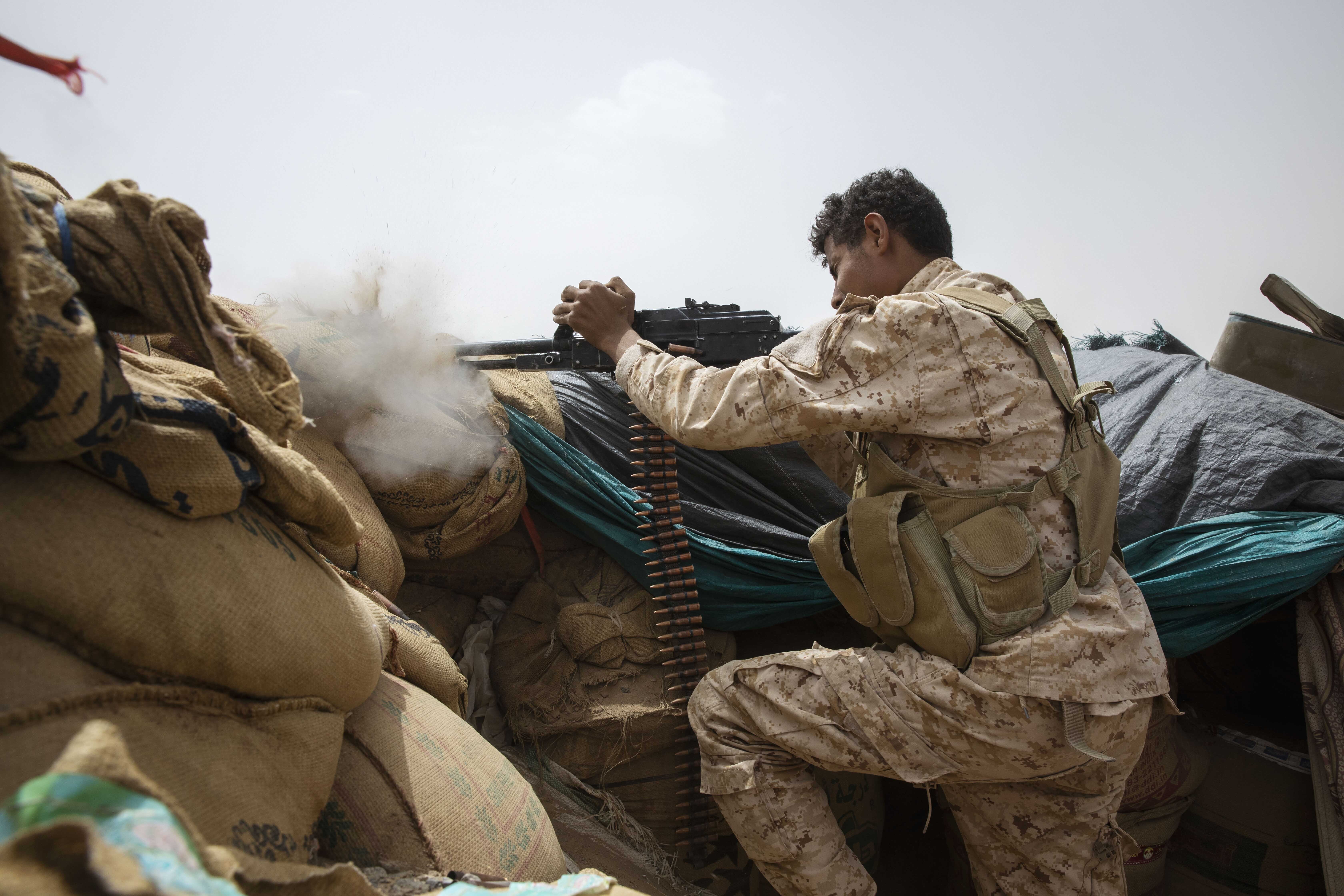 A Yemeni fighter backed by the Saudi-led coalition fires his weapon on the front lines of Marib, Yemen, Saturday, June 19, 2021. (AP Photo/Nariman El-Mofty)