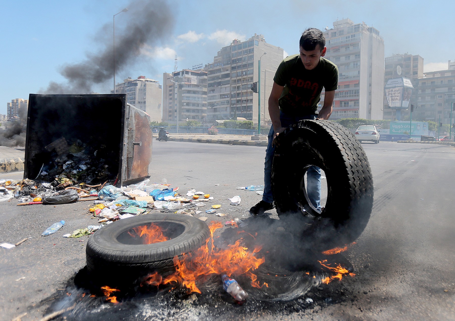 Lebanese protesters burn tires to block a main highway, during a protest against the increase in prices of consumer goods and the crash of the local currency, Beirut, Lebanon - 17 Jun 2021