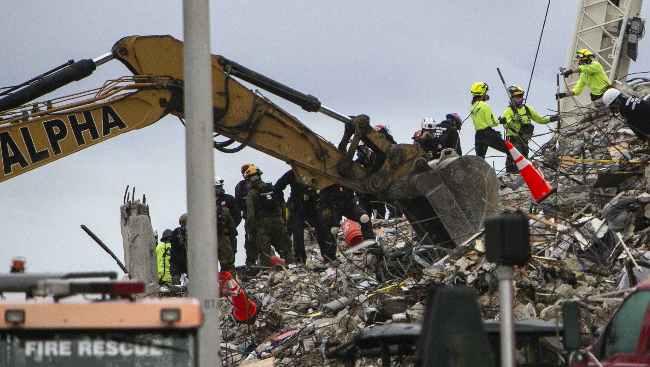 Rescue workers dig through the rubble with the aid of a backhoe at site of the collapsed condominium in Surfside, Fla., Monday, June 28, 2021. (Jose A Iglesias/Miami Herald via AP)