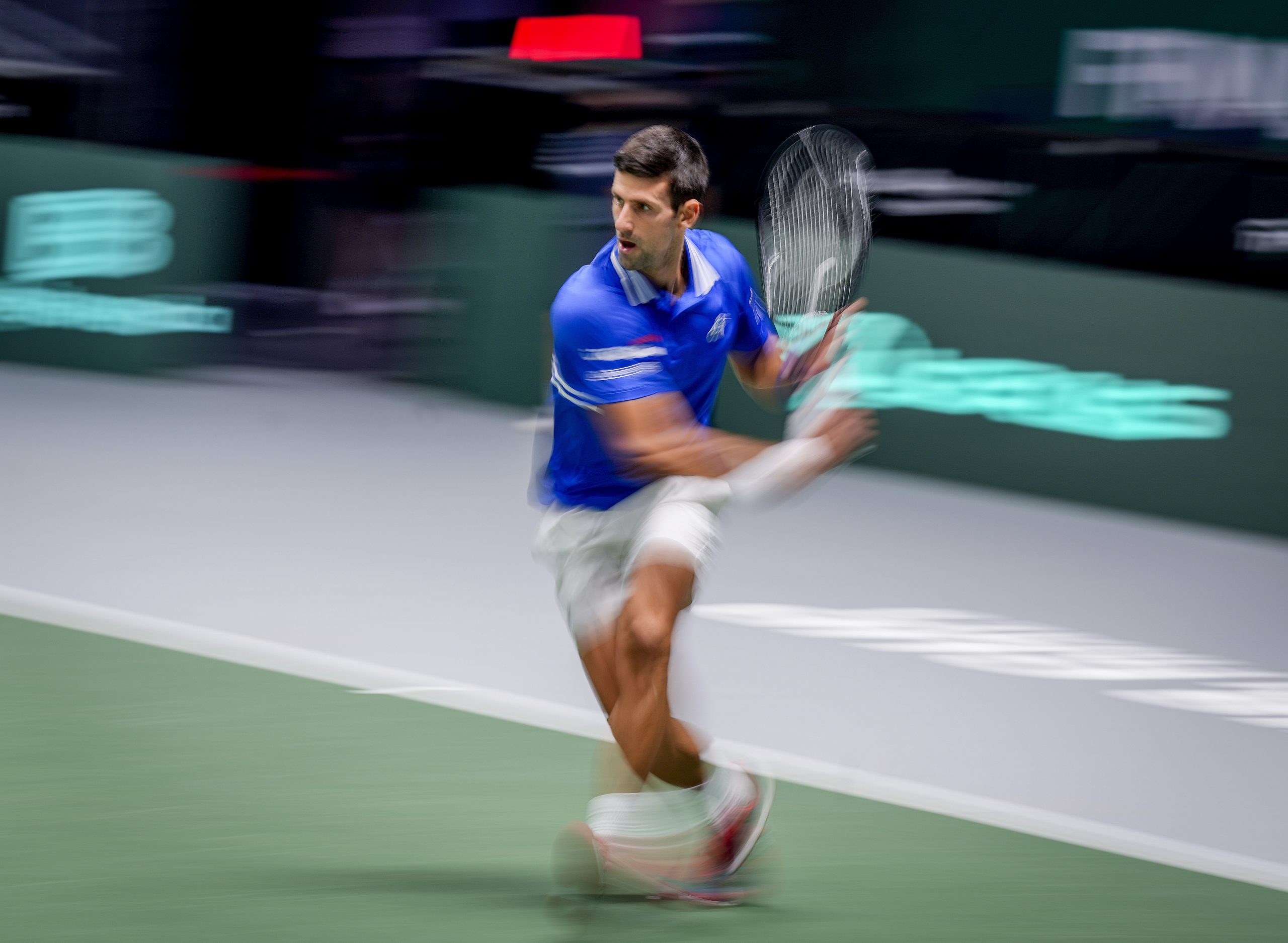 Serbia's Novak Djokovic runs for the ball during his match against Austria's Dennis Novak in a Davis Cup group F match between Serbia and Austria in Innsbruck, Austria, Friday, Nov. 26, 2021. (Photo/Michael Probst)