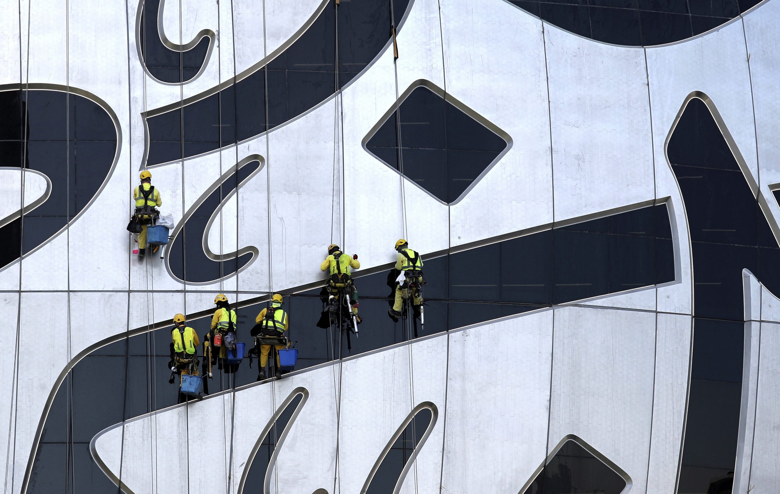 02022021 Laborers hang from The Museum of the Future, a museum of innovation and design currently under construction in Dubai, United Arab Emirates, Tuesday, Feb. 2, 2021. (AP Photo/Kamran Jebreili)