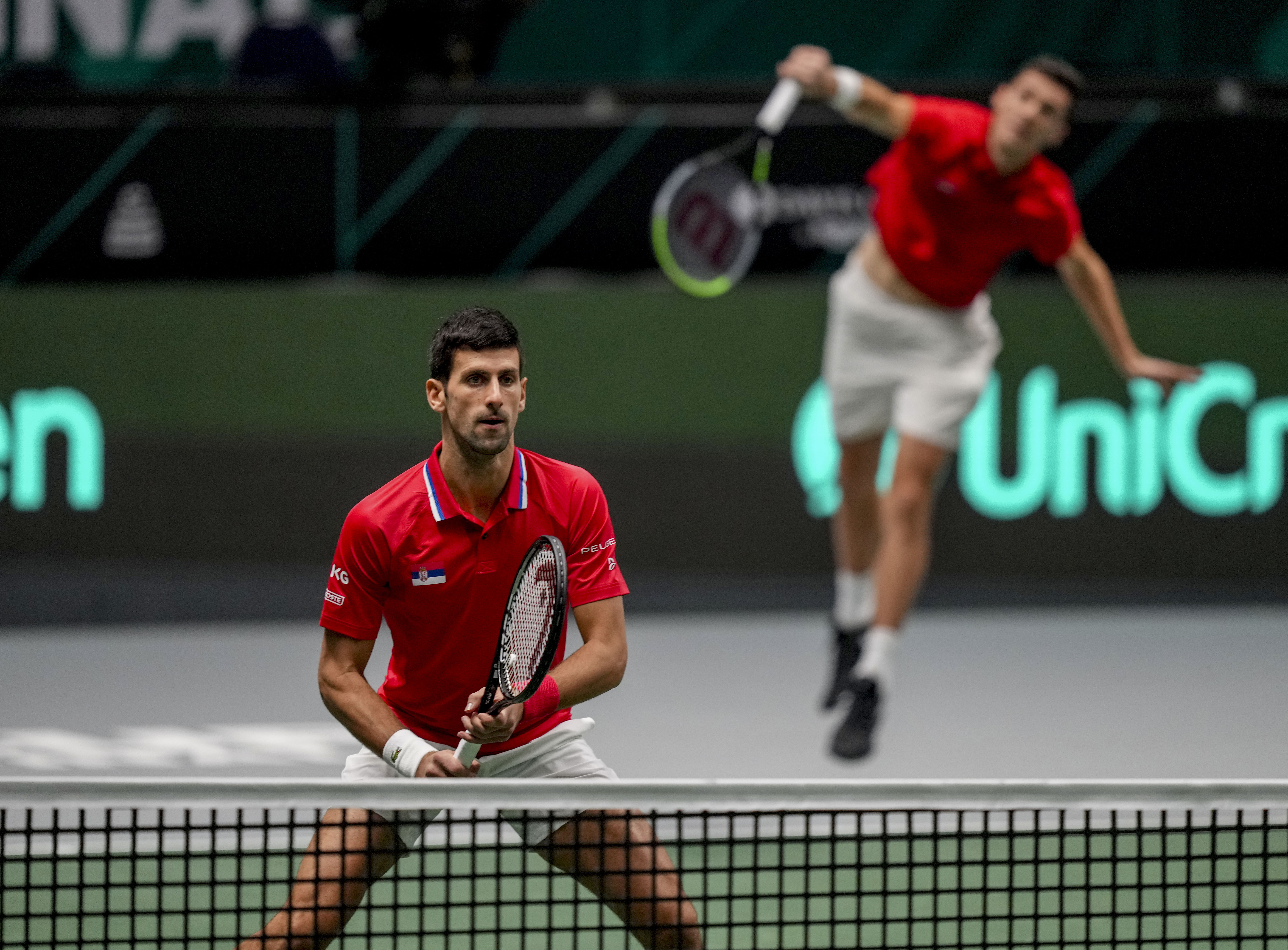 Serbia's Novak Djokovic, left, and Nikola Cacic play against Ger,amy's Tim Puetz and Kevin Krawiwetz in a Davis Cup group F match between Serbia and Germany in Innsbruck, Austria, Saturday, Nov. 27, 2021. (Photo/Michael Probst)