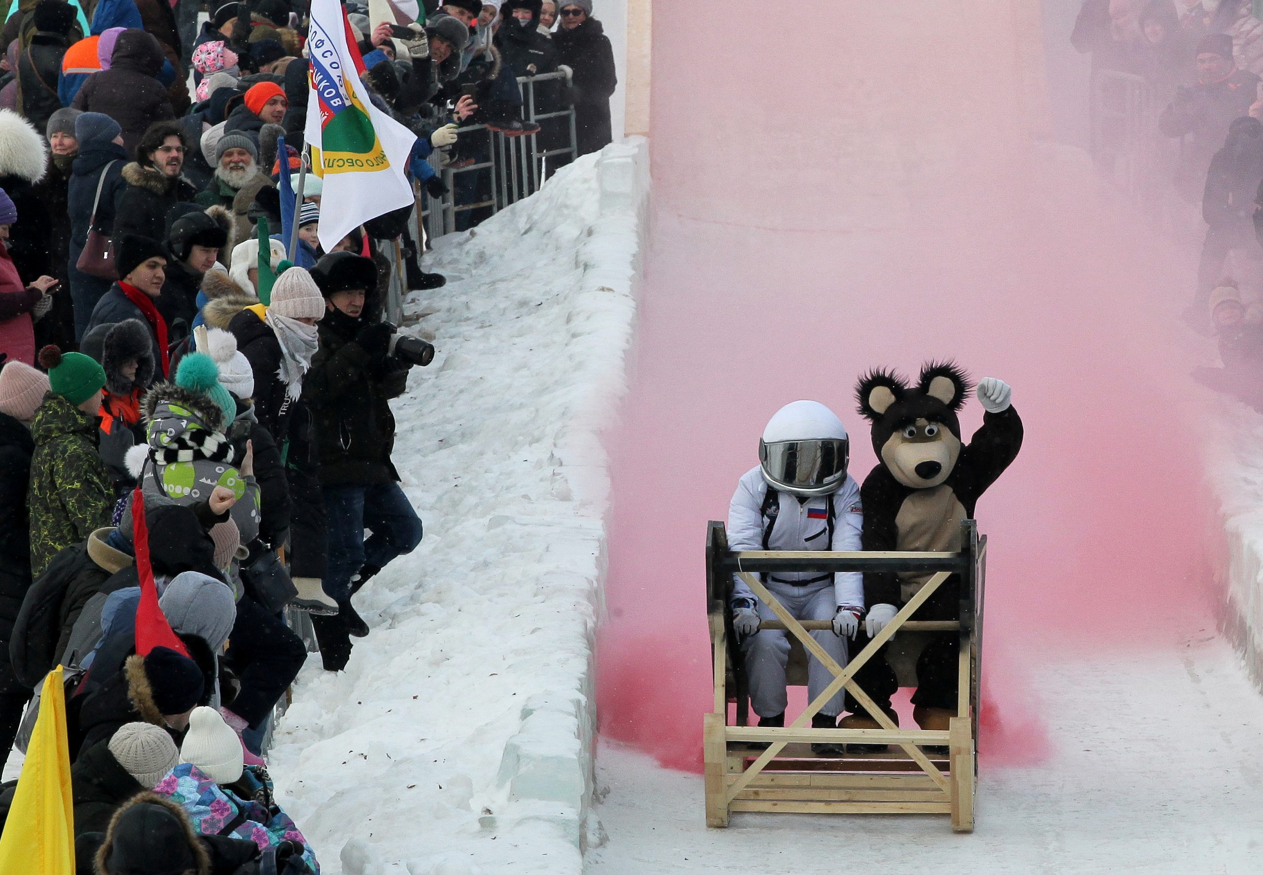 07022021 Participants ride down a slope during the "Sunnyfest" festival of unusual sledges in the town of Mamadysh in the Republic of Tatarstan, Russia February 6, 2021. Picture taken February 6, 2021. REUTERS/Alexey Nasyrov     TPX IMAGES OF THE DAY