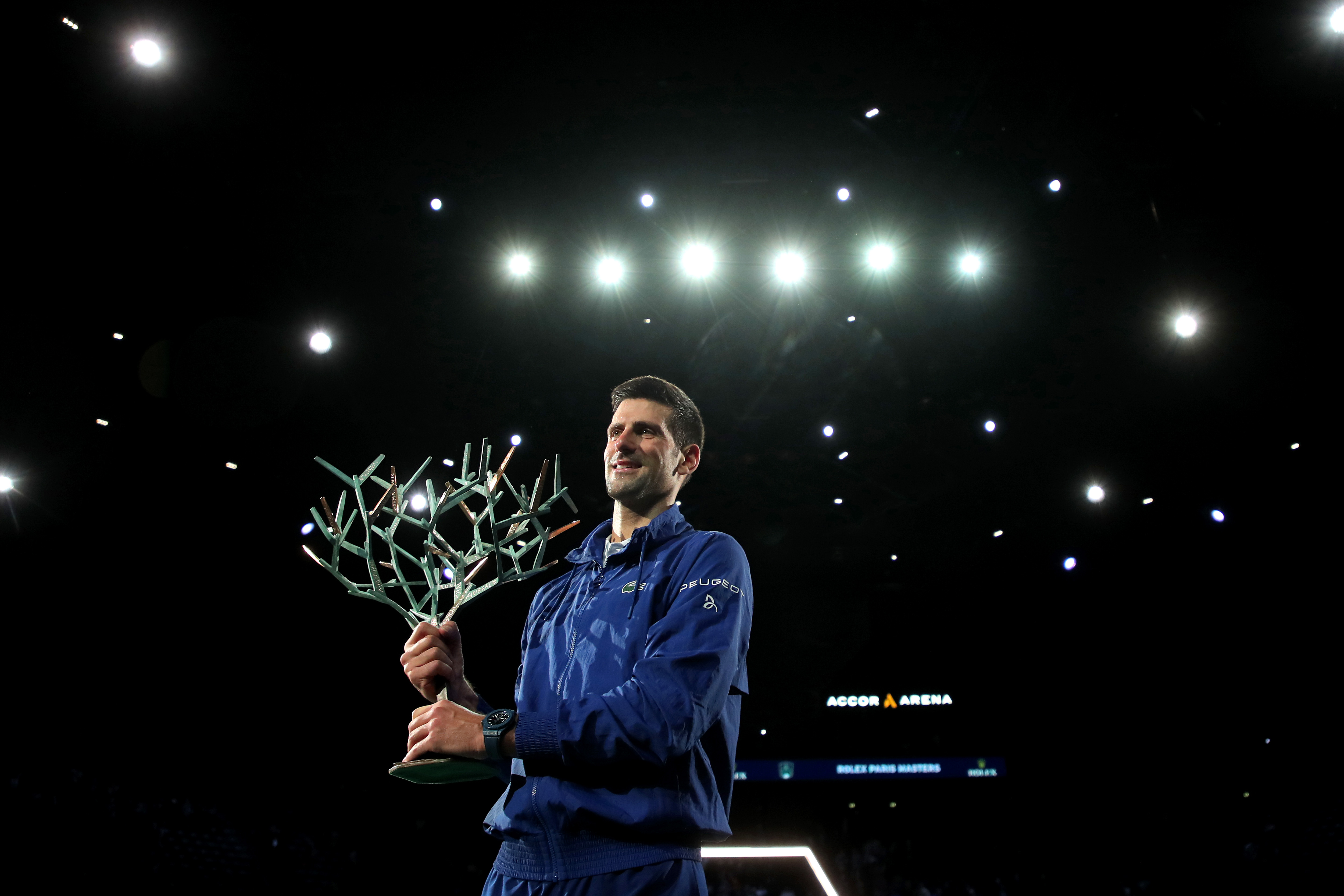epa09570180 Novak Djokovic of Serbia celebrates with the trophy after winning the final match against Daniil Medvedev of Russia at the Rolex Paris Masters tennis tournament in Paris, France, 07 November 2021.  EPA-EFE/CHRISTOPHE PETIT TESSON
