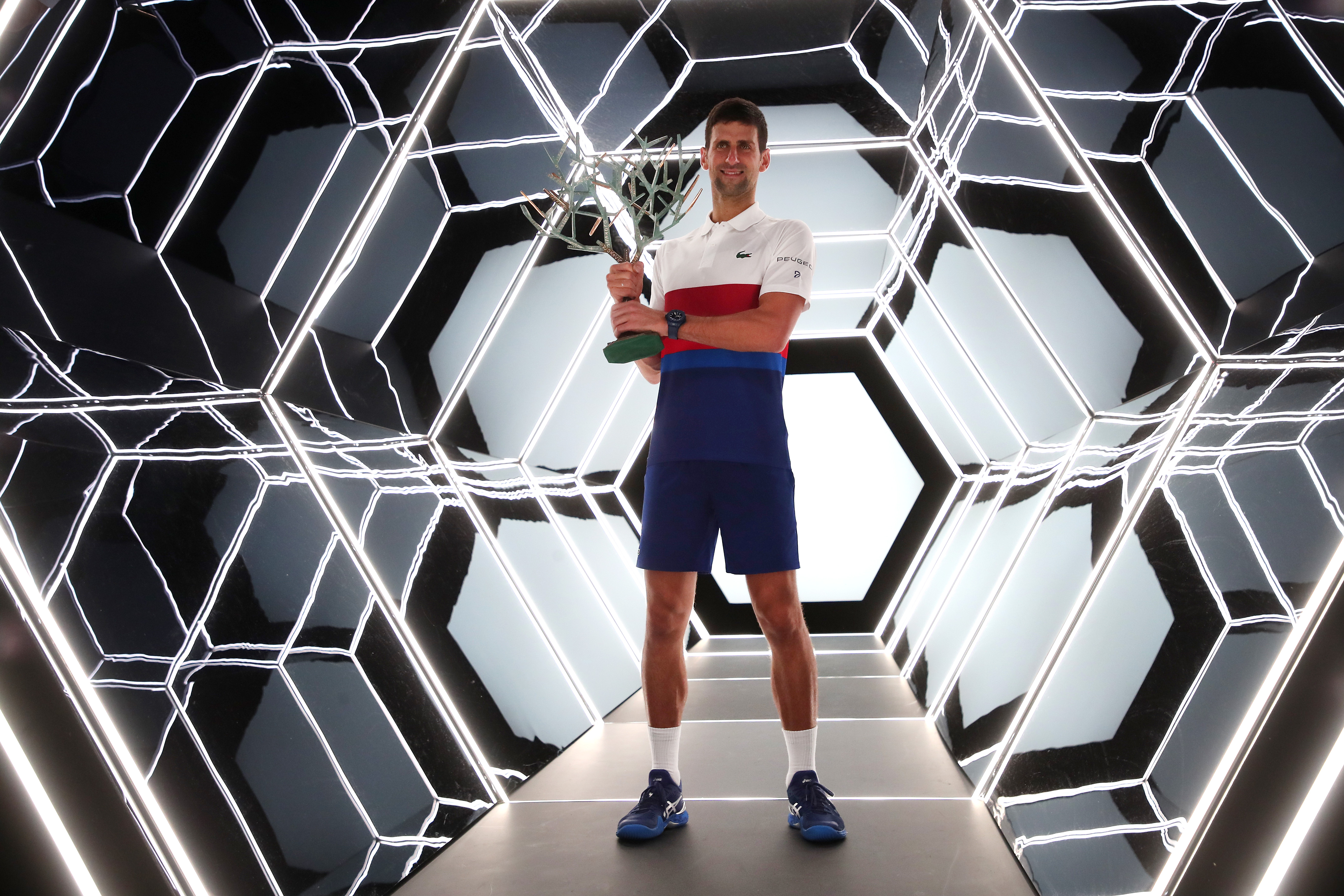 epa09570227 Novak Djokovic of Serbia celebrates with the trophy after winning the final match against Daniil Medvedev of Russia at the Rolex Paris Masters tennis tournament in Paris, France, 07 November 2021.  EPA-EFE/CHRISTOPHE PETIT TESSON
