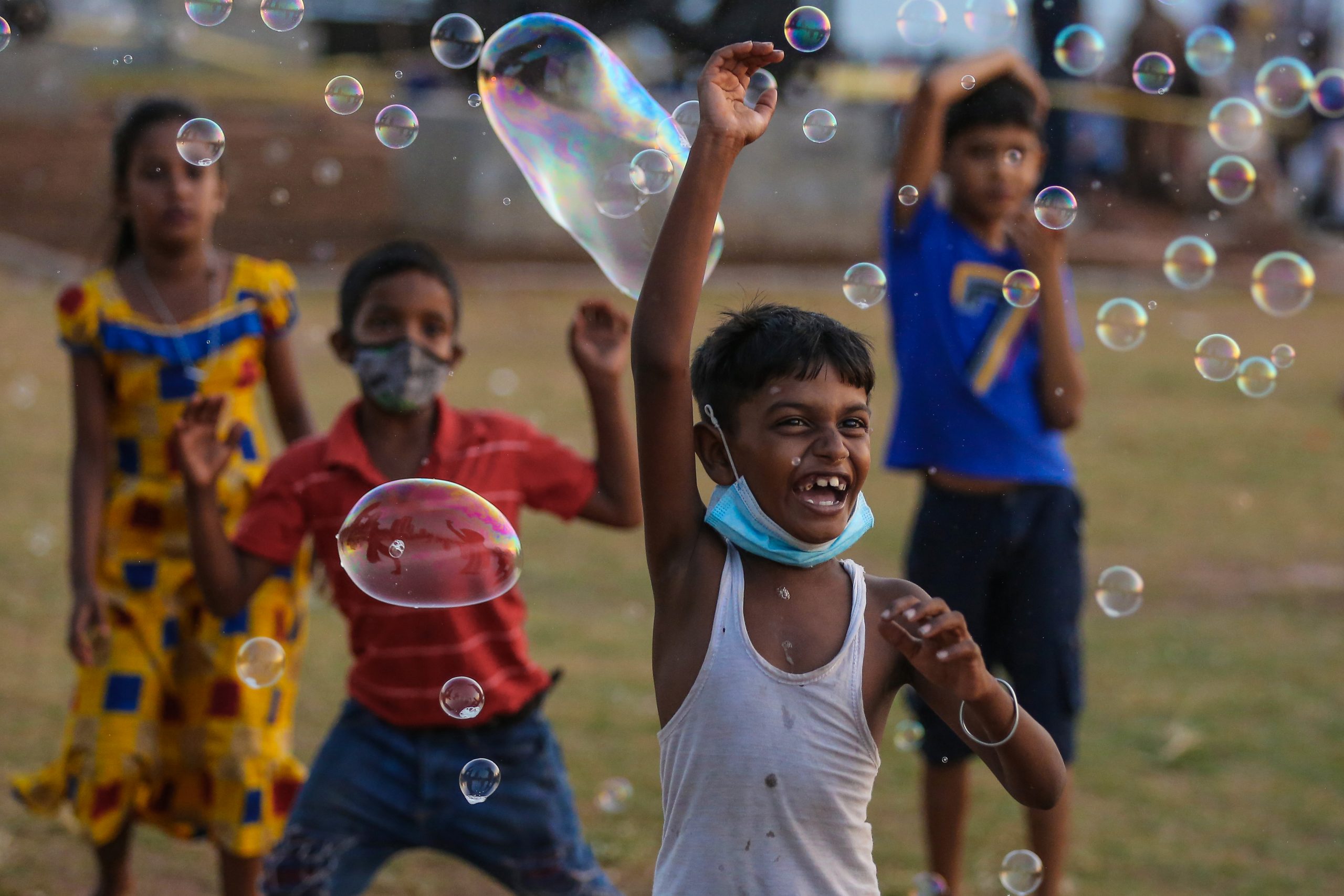 epa09012462 Sri Lankan children's play with soap bubbles at the Galle Face sea promenade in Colombo, Sri Lanka, 14 February 2021  EPA-EFE/CHAMILA KARUNARATHNE
