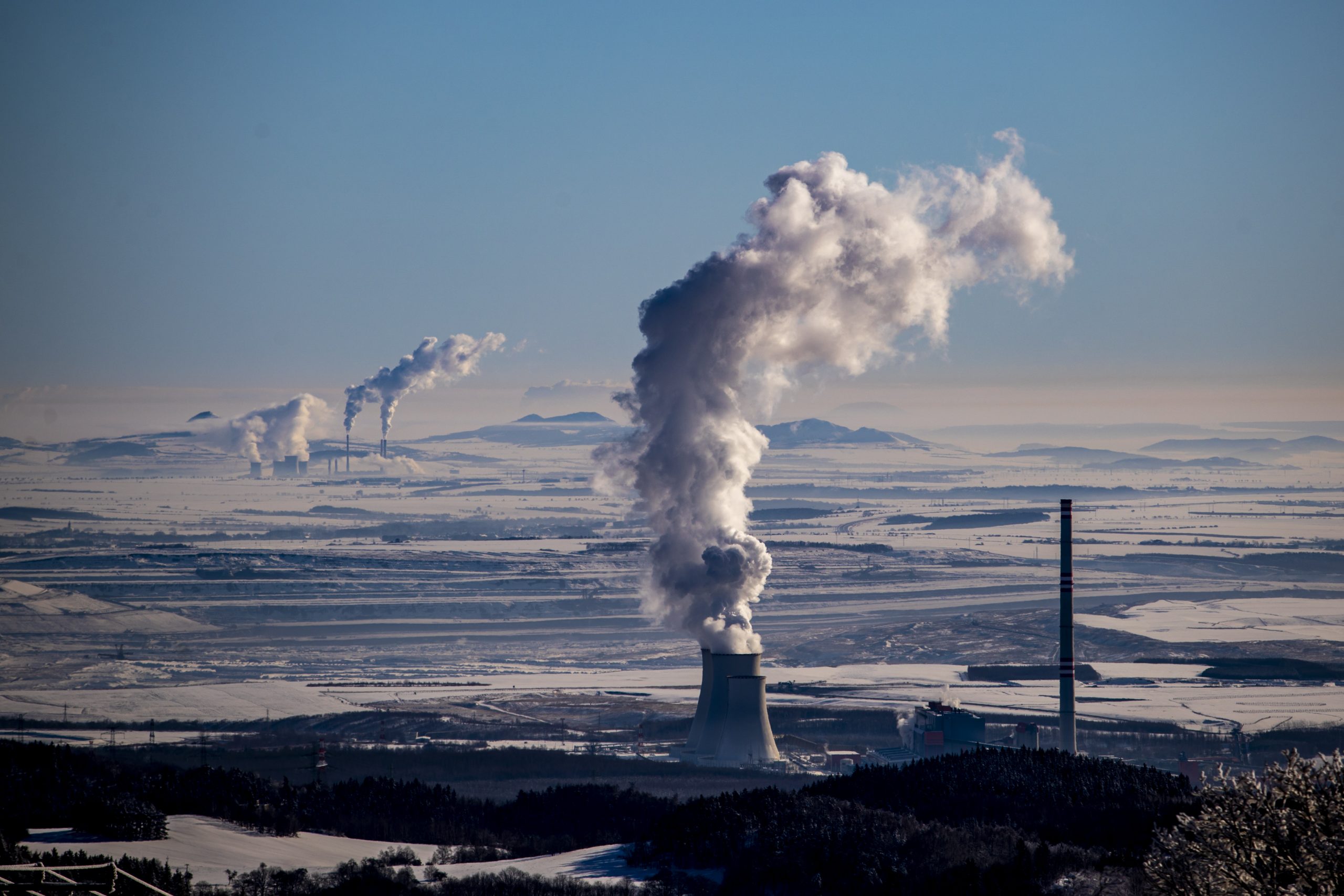 epa09011619 Steam escape from the chimneys of the coal-fired power plant in Prunerov, pictured from village of Vysluni, Czech Republic, 14 February 2021.  EPA-EFE/MARTIN DIVISEK