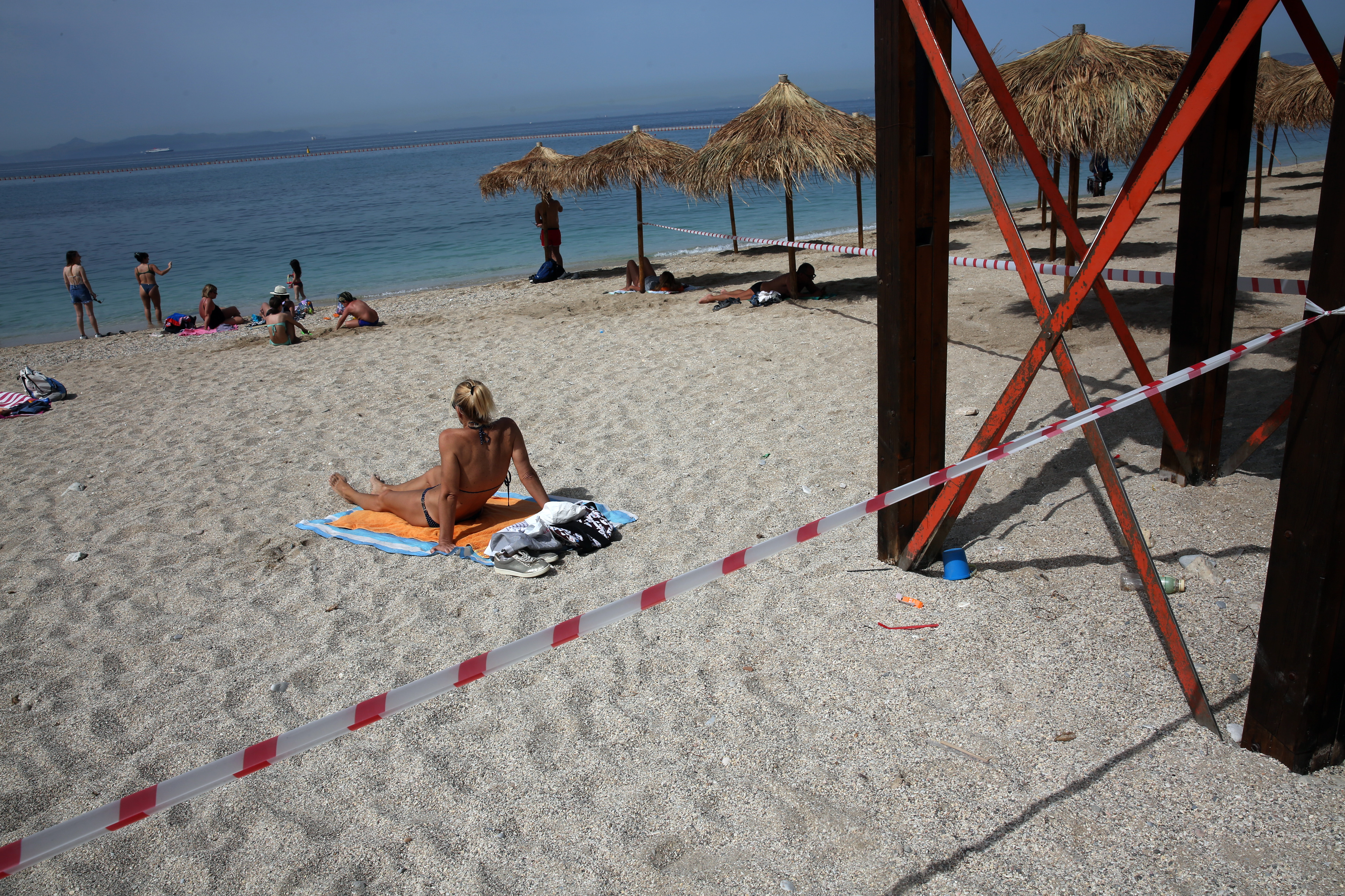 epa09183409 People enjoy the sea on a beach in a summer resort near Athens, Greece, 07 May 2021. Beaches charging entrance fees are expected to reopen as of 08 May based on safety protocols.  EPA-EFE/ALEXANDROS BELTES