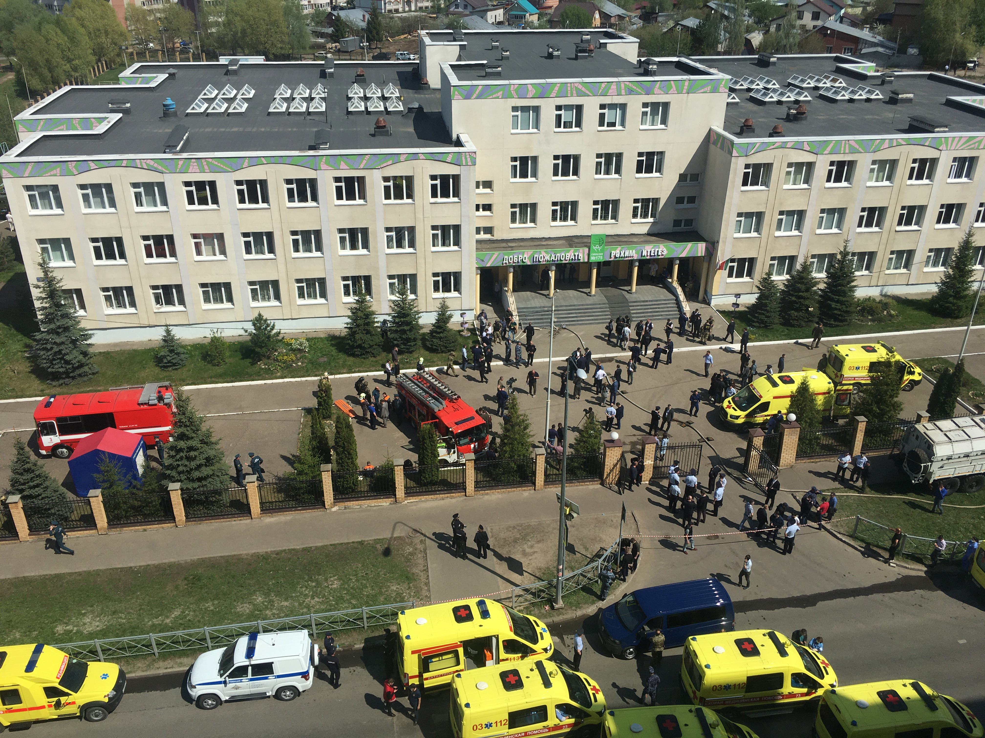 epa09190730 Ambulances and police cars gather outside a school in the aftermath of a shooting, in Kazan, Russia, 11  May 2011. The state news media reported that at least 11 people were killed in the shooting at the school.  EPA-EFE/Anton Raykhshtat
