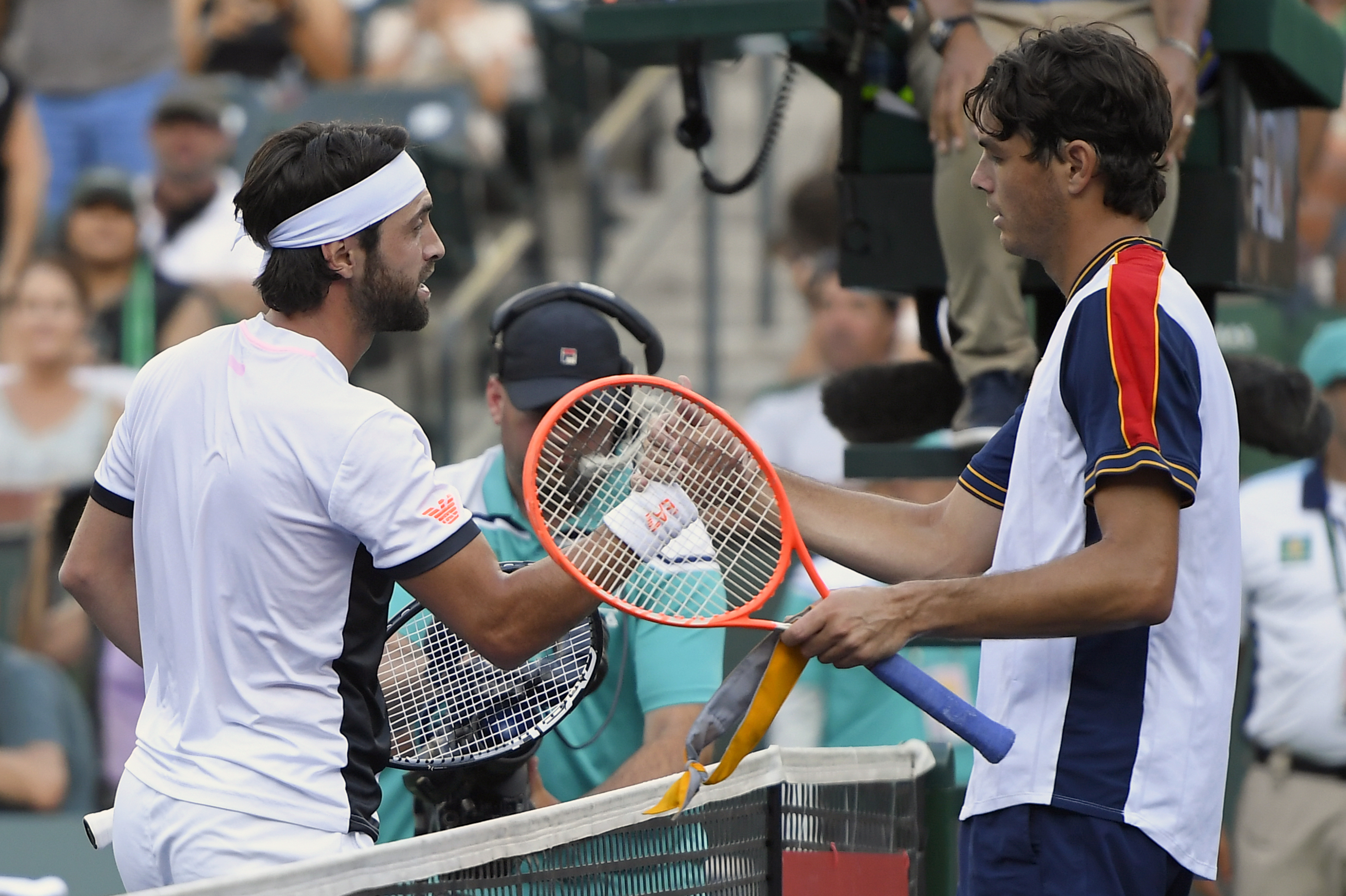 Nikoloz Basilashvili, of Georgia, left, shakes hands with Taylor Fritz after defeating him in a semifinal at the BNP Paribas Open tennis tournament, Saturday, Oct. 16, 2021, in Indian Wells, Calif. (AP Photo/John McCoy)