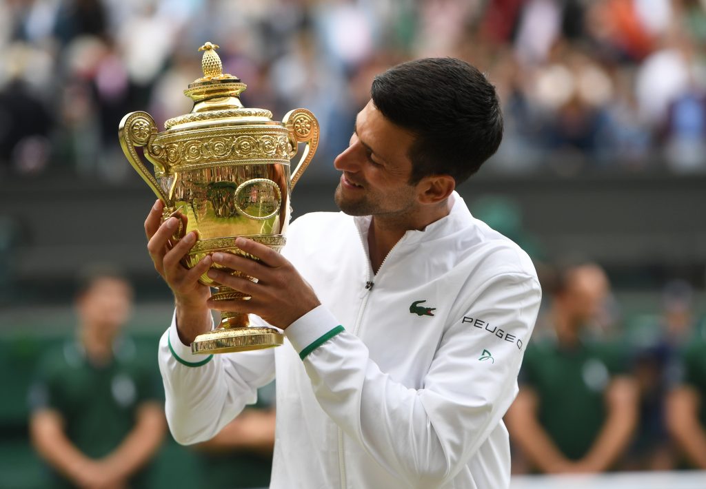 epa09337879 Novak Djokovic of Serbia poses for a photo with the trophy after winning the men's final against Matteo Berrettini of Italy at the Wimbledon Championships, Wimbledon, Britain 11 July 2021.  EPA-EFE/NEIL HALL   EDITORIAL USE ONLY