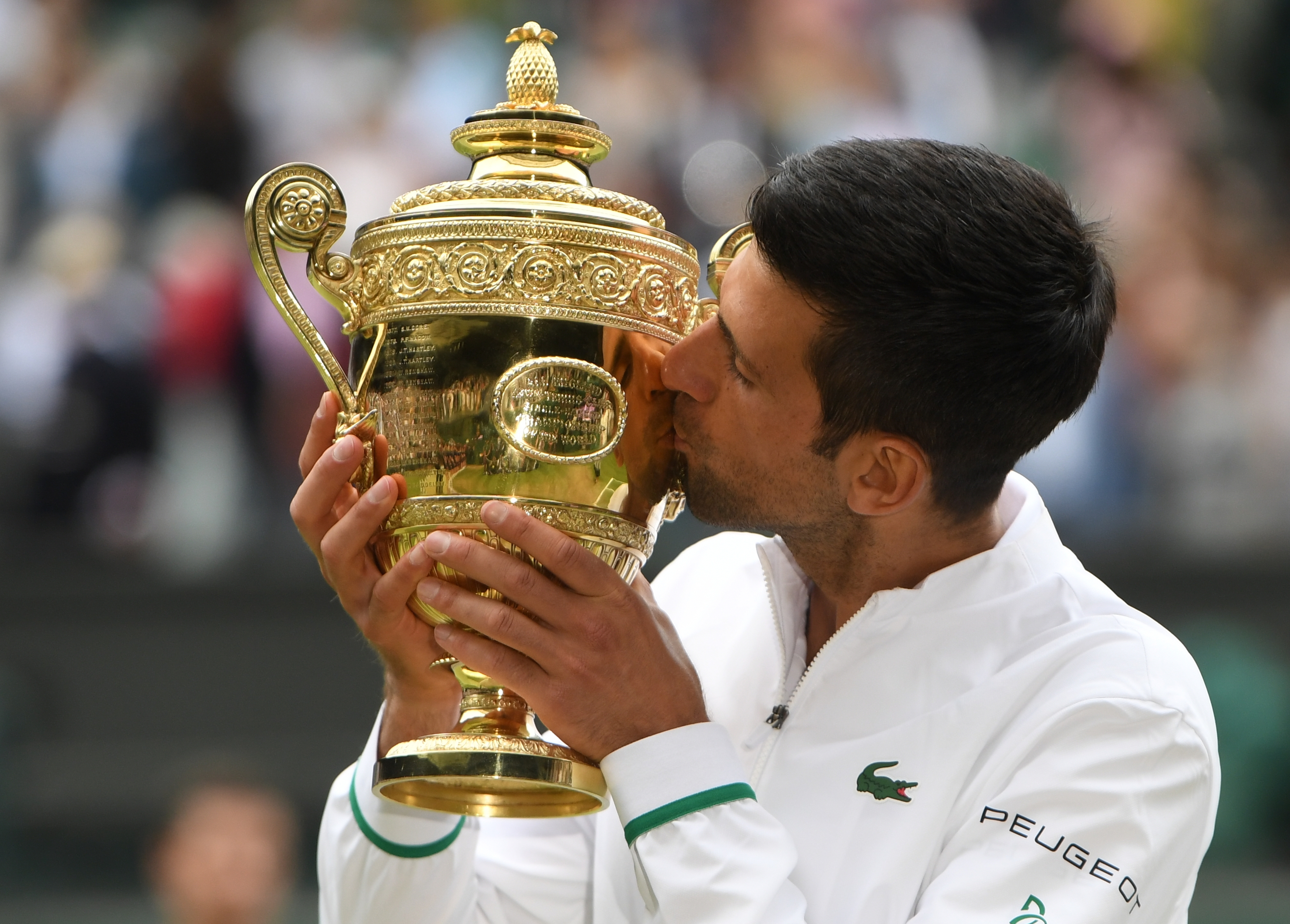 epa09337870 Novak Djokovic of Serbia poses for a photo with the trophy after winning the men's final against Matteo Berrettini of Italy at the Wimbledon Championships, Wimbledon, Britain 11 July 2021.  EPA-EFE/NEIL HALL   EDITORIAL USE ONLY