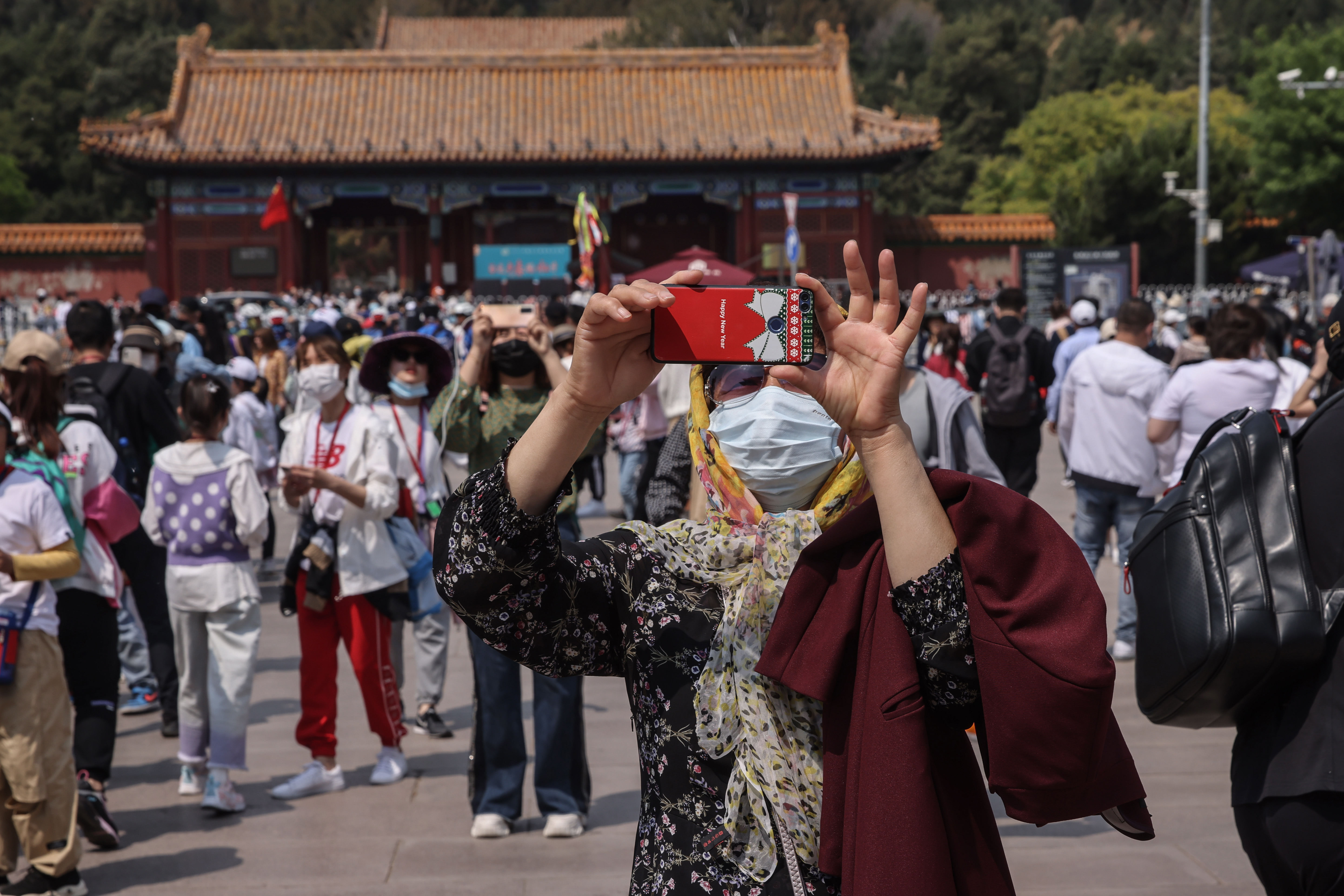 epa09175088 Tourist takes photos outside the Forbidden City in Beijing, China, 03 May 2021. The Labour Day holiday begins from 01 May to 05 May that expects to see around 265 million domestic trips during the holidays.  EPA-EFE/WU HONG