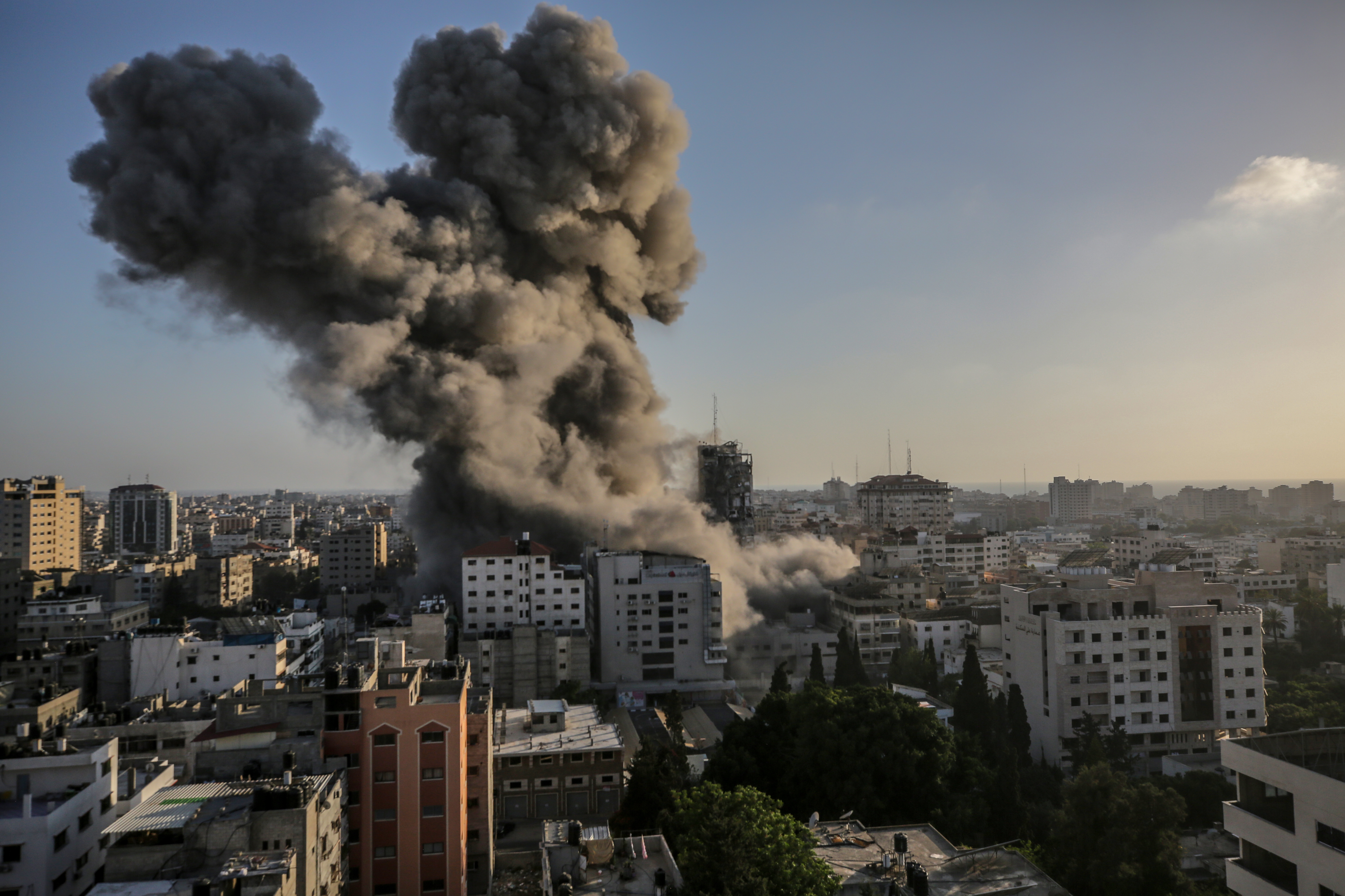 Smoke and flames rise after an Israeli strike Al-Shorouq tower in Gaza City
