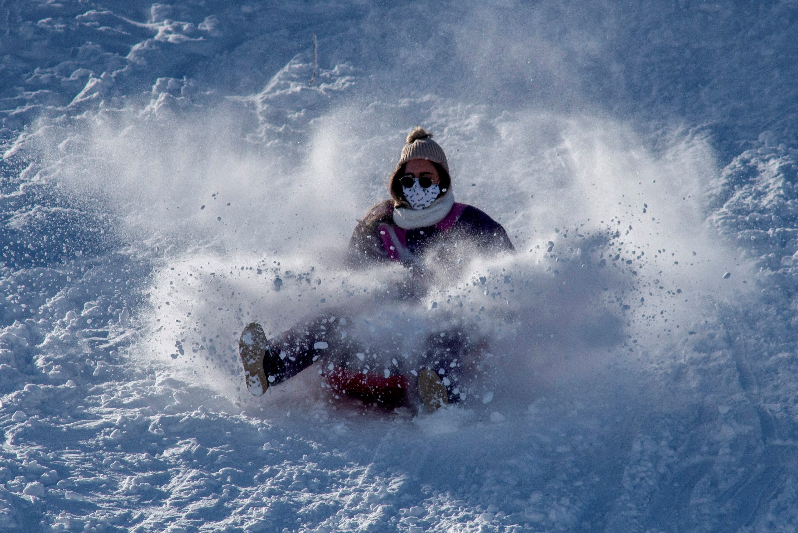 epa08915228 A woman enjoys of the snow in the village of Cabeza de Manzaneda (Ourense), northern of Spain, 02 January 2021, after the heavy fall snow in the north of the country.  EPA-EFE/Brais Lorenzo